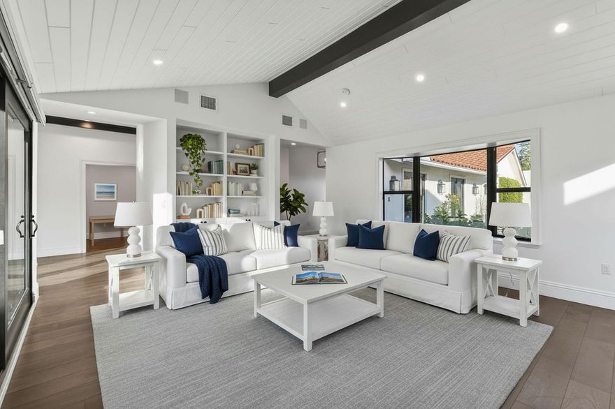 Experience refined coastal living in this stunning custom re-built beach compound. The thoughtfully designed floor plan offers 3 bedrooms, 3.5 baths, a welcoming living room, and a versatile media room with a full en-suite bath, wet bar, and full-size wine refrigerator--perfect for entertaining. The re-build included raised ceilings throughout with wood accent beams enhancing the architectural character, while European wood floors, a gourmet kitchen with high-end appliances, gas range, and Moroccan-inspired mosaic tile in the kitchen and baths elevate the interiors. Enjoy complete privacy in the beautifully landscaped backyard featuring a pool and infinity-edge spa, all secured by electric gates. A true oasis within the gated community of Ocean Walk. *Some pictures are virtually staged.