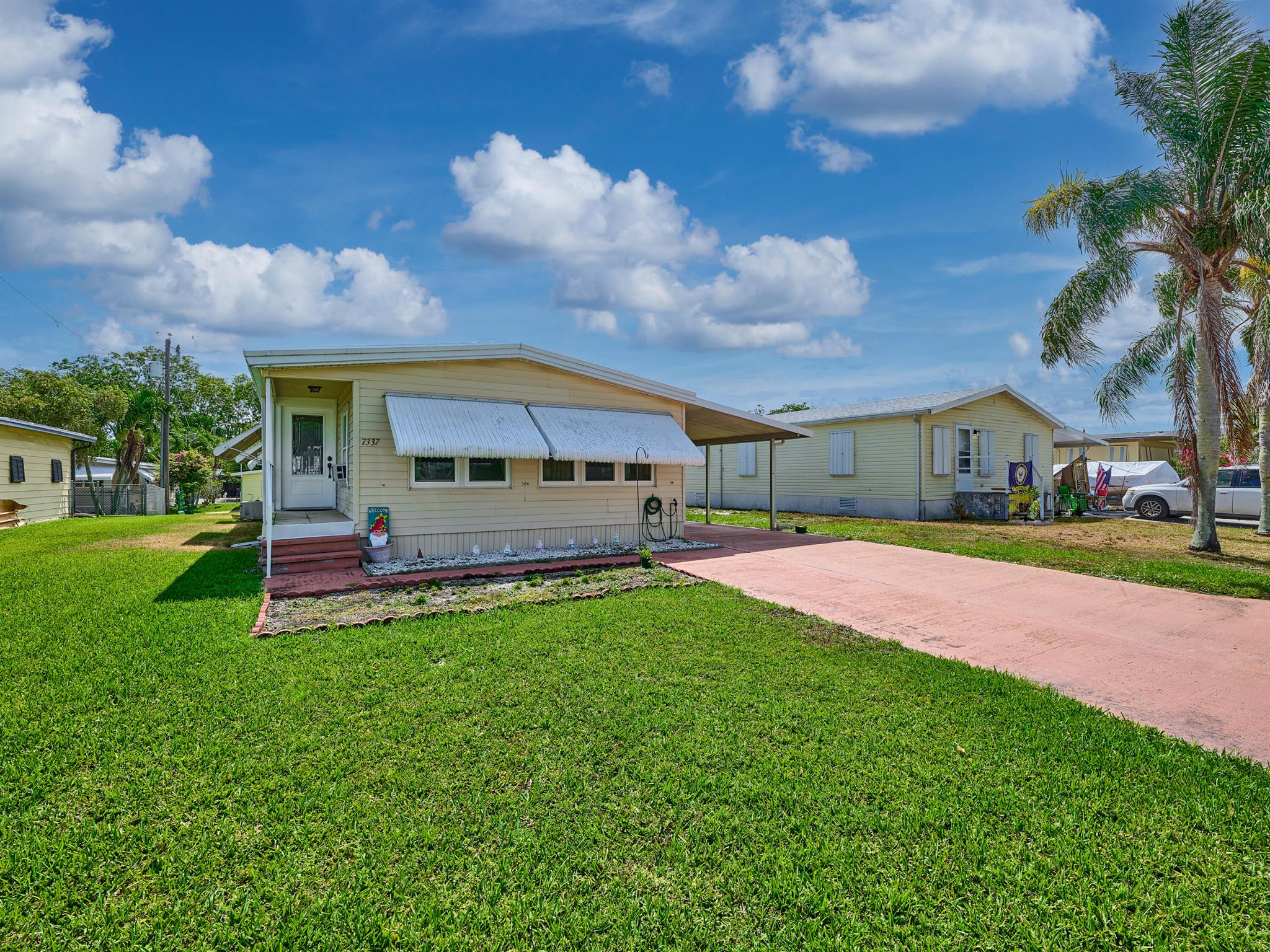 Beutifully updated 2 Bedrm/2 Bath Manufactured home in Ridgeway, all ages, community in Hobe Sound. Newer Kitchen w expansive wooden cabinets, attractive granite countertops, under mounted stainless sink w pull out spray faucet. The LR is light & bright w laminate floors & dining area w extensive storage. The front FL Room is a big bonus you can use as additional living space or perhaps an extra sleeping area. The Master Bedrm is large w walk in closet, new vanity, chair height toilet & tiled step in shower. The 2nd Bedrm is also a good size w a double closet & updated bath on the hall. New AMS Aluminum Roof-over 2015, New Windows 2017, New A/C w heat pump & new duct work 2016, New Hot water heater 2016, all plywood subfloors. Mins to Ocean beaches, shopping, restaurants. YOU OWN THE LAND