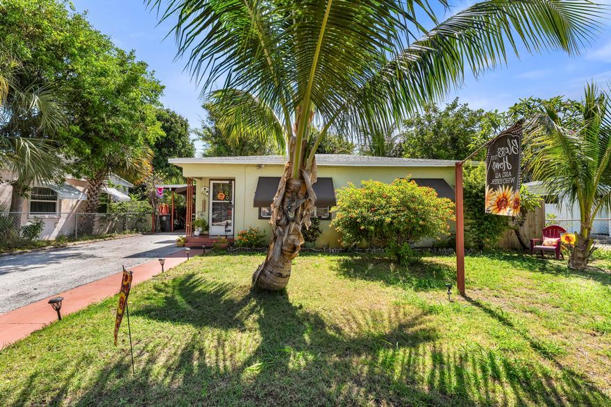 Step into this beautifully maintained 2-bedroom, 1-bath cottage style home in the heart of West Palm Beach with no HOA! There is endless potential for homeowners or investors alike! This move-in-ready property features a 2024 roof, A/C replaced in 2022, fresh exterior paint, tile flooring throughout, and a large covered back porch. The cozy layout is complemented by excellent parking with a carport and a long driveway.Enjoy a tropical backyard oasis perfect for entertaining and relaxing. Featuring large bamboo , coconut palms, string lights, and a concrete patio for al fresco dining. Exterior electrical outlets, a fully fenced yard for added seclusion, and plenty of room for a pool add to the appeal.  Two aluminum sheds provide ample storage for all your needs.   Conveniently located just minutes from downtown, the airport, shopping, dining, and beaches, this property is ideal as a primary residence, vacation home, or investment opportunity. Rare combination of location, updates, outdoor charm, and no HOA restrictions!