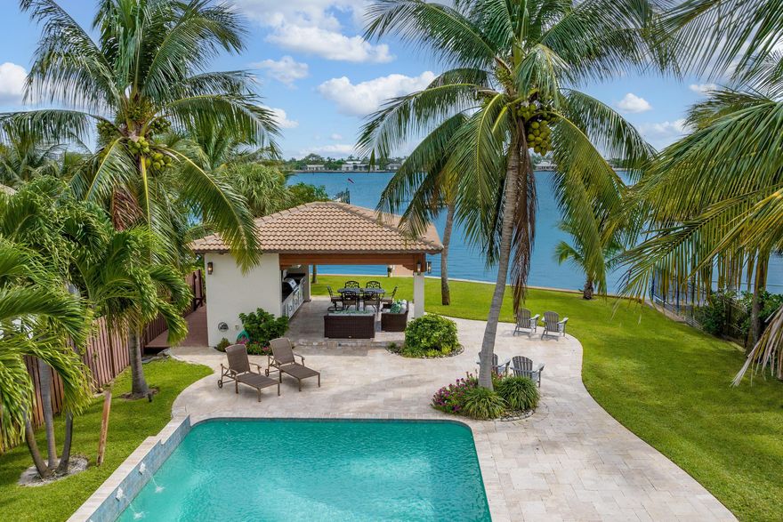 Welcome home to your direct intracoastal paradise which boasts a 4 bedroom, 3 bathroom home featuring approximately 81 feet of water frontage and a 276' dock equipped with an 8 ton boat lift. The immense saltwater pool and covered pavilion complete with a summer kitchen, propane grill, storage closet, half bath & outdoor shower make it the perfect place to host friends & family year-round. Renovations from 2011 to 2013 included a new seawall, Wolf & Sub-Zero appliances, new A/C system, new electrical wiring, new plumbing and full impact windows & doors. Experience the magical sunrise views each morning and the very best dining, shopping & beaches from its' unique central location. The ultimate boating & entertaining lifestyle is found right here in this Lake Worth Beach gem.