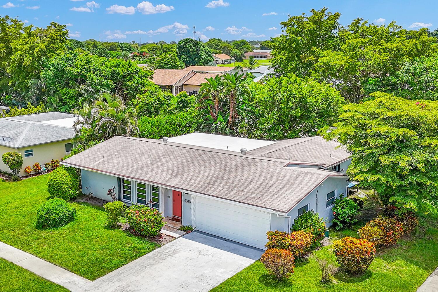 RENOVATED home with a 2-CAR GARAGE, upgraded kitchen, & polished porcelain tile floors that connect every room to the private screened-in porch with ceiling fan & mounted TV. Featuring a transitional modern design & private backyard, this meticulously cared-for single-family home is in an active, PET-FRIENDLY 55+ community in the heart of Delray Beach.The open-concept kitchen was remodeled in 2024 with white shaker cabinets, quartz countertops, waterfall island with a deep sink, & stainless-steel appliances. The 2 split master bedroom offer walk-in closets & en-suite bathrooms renovated in 2022 for privacy.The living room blends contemporary sophistication & comfort, featuring marble-look porcelain tile flooring, & floor-to-ceiling windows filling the space with natural light.