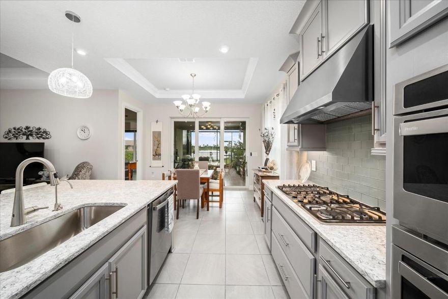 Why wait for new construction! Pristine 2022 Taylor Morrison built Capri model with over $110,000 of upgrades in the desirable Traditions Vitalia 55+ community. Natural gas community. Impact glass throughout. This leaves buyers wanting for nothing - see feature/upgrade sheet in photos for full details. Beautifully landscaped yard features extended 286 Sq Ft screened in lanai with brick pavers and natural gas outlet for grill and full unimpeded lake views. Vitalia is a 55+ resort-amenity community that includes the Captiva Clubhouse, resort & lap pools, exercise room, putting green, cable, hi-speed internet, alarm monitoring, landline, guarded gate, water for irrigation, property manager, and staffed clubhouse.