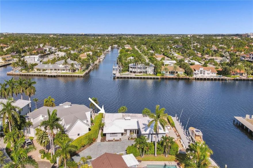 This amazing point lot has over 200 feet of waterfront with 100+ on the intracoastal. Brand new seawall upgraded to existing standards surrounds the property and includes a 27,000 pound boatlift.  Existing Three bedroom, 4 bath home is lovely with a mid century design and gorgeous Ketchum/Cuban tile floors, recently updated with fresh paint and modern lighting. Completely renovated guest suite includes one bedroom /one bath above the garage, two bedrooms and two baths in the existing house. Ready for your custom designed home or live in the existing charming home.Amazing views, amazing potential!