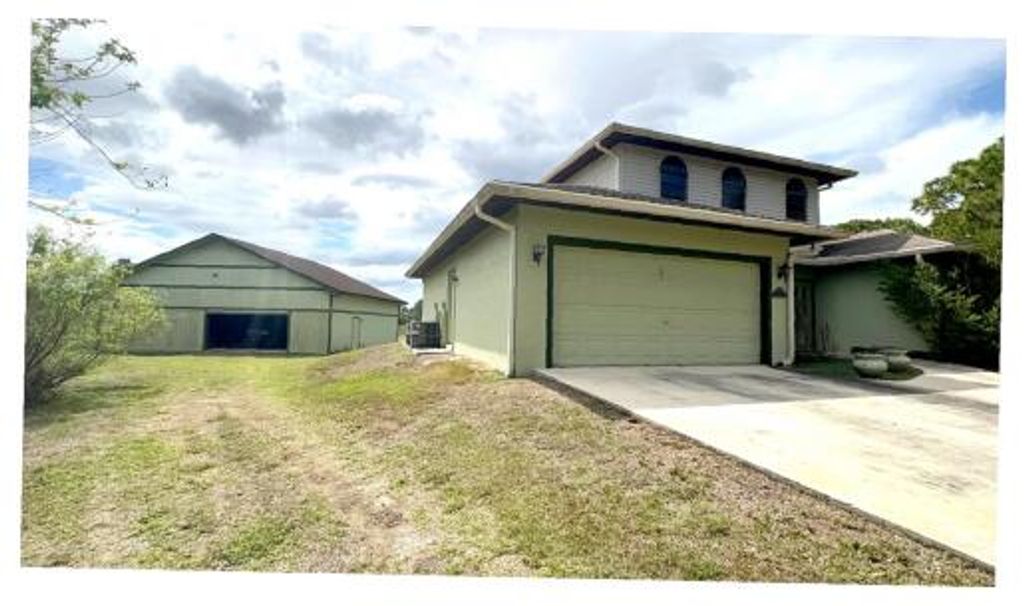 Photo of 12455 Grumman Way, Port Saint Lucie, FL 34987 (MLS # B26005503)