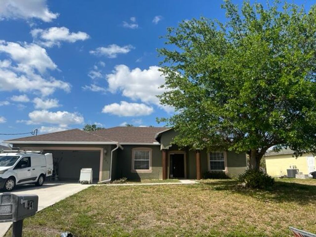 Photo of 541 SW Halkell Avenue, Port Saint Lucie, FL 34953 (MLS # R10792554)