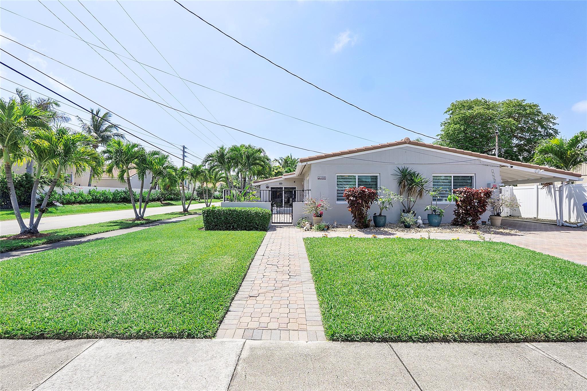 Explore this stunning open-concept home with pool on a corner cul-de-sac in a quiet neighborhood. 3 updated bedrooms (with ceiling fans)and a possible 4th bedroom/office, with 3 updated full bathrooms??one doubling as a cabana bath. Modern amenities like hurricane impact doors/windows(2018), A/C (2017), tankless water heater, Wi-Fi-enabled washer/dryer, and a standby generator (2021). Relax or entertain in the gated front porch, outdoorkitchen with built-in grill/sink, fruit trees, and privately fenced yard. Re-roof (2010). Carport and expanded parking for up to 4 vehicles. Minutes from beaches,downtown Hollywood, Dania Pointe, and close to Holland Nature Park, boat ramps, golf courses, and major airports. Perfect Airbnb potential. Pet friendlycommunity with no HOA!