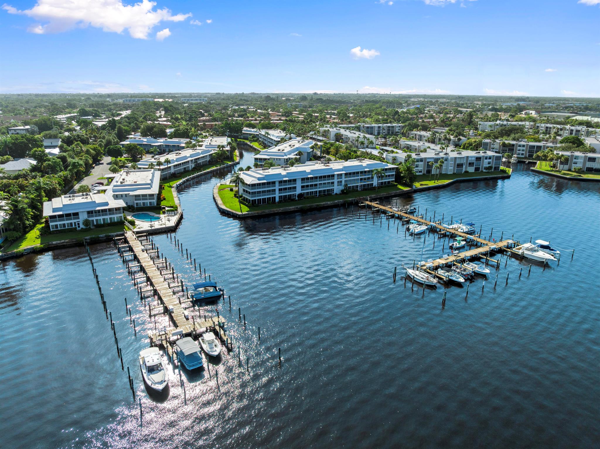 Waterfront 2Bed 2Bath corner condo in Windjammer with 30' Boat Dock (Slip #119). Windjammer offers Community Marina, Clubhouse & 3 Heated Swimming Pools. Kitchen features 30'' White cabinets with Corian counters with waterfall edge, spacious breakfast bar. Updated insulated windows with accordion hurricane shutters. Master bedroom has sliding glass doors to screen porch & large walk-in closet. Master bath features dual sinks & tub/shower combination. Large guest bedroom has 2 closets. 2nd bath has separate shower with glass doors. Large screen patio with tile floors, storage closet & roll down shutters. Additional storage closet in laundry room. Water Heater was replaced in 2008 & A/C is 2004. Windjammer is a 55+ Adult community. Conveniently located near historic downtown Stuart.