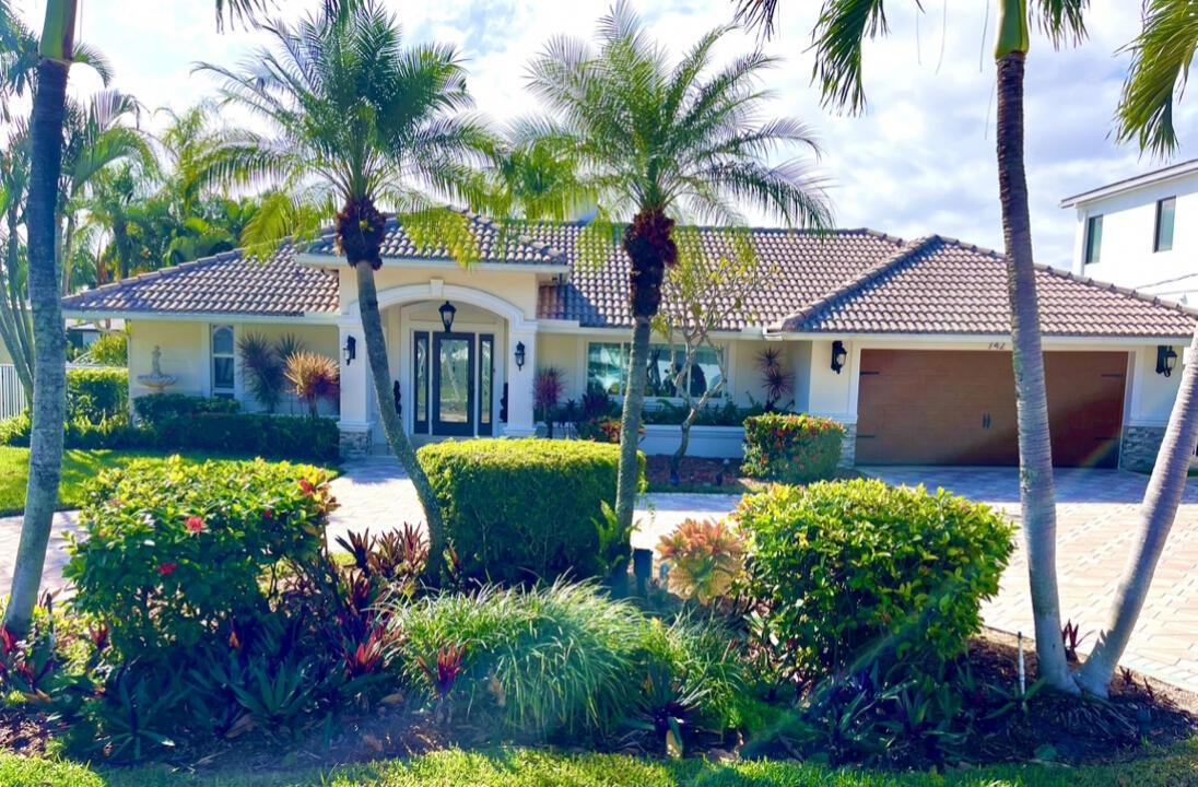 742 Berkeley St, Boca Raton, FL, USA. Beautiful southern exposed deep waterfront home in the prestigious Bel-marra community of East Boca Raton. Front yard has a paved, circular driveway. Interior has a bright and open split floor plan with a 2-sided fireplace. Impact doors and windows throughout, new AC/HVAC system, stainless kitchen with granite counters. Furnishings are negotiable. Outside has a spacious paved deck with pool and outdoor grill. 85' of waterfront, 50' dock with 220v power. There's a 16k boat lift and 2 floating docks for your kayaks and jetskis. By boat this home is minutes to Lake Boca and its inlet and there are no fixed bridges. Minutes to Mizner Park or Atlantic Ave's entertainment.