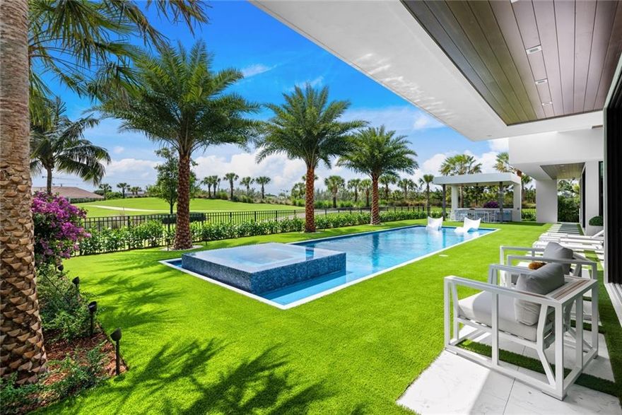 Incredible open golf course views are showcased in this newly completed residence in the highly desirable gated community, The Enclave at Coral Ridge Country Club. This single-level custom residence is built to a whole new level of customization with multiple windows & doors throughout. Extensive custom cabinetry & finishes with ceiling heights up to 14 ft. The modern open floorplan is extremely practical with the 5th bedroom as a home office option. Stunning great room open to Chef's kitchen is beautiful as well as functional access to the family room & open to the outdoor living area, summer kitchen & custom heated pool (53x15). The ultra-luxurious Master Suite also captures fairway views with the secondary bedroom suites off private wings.