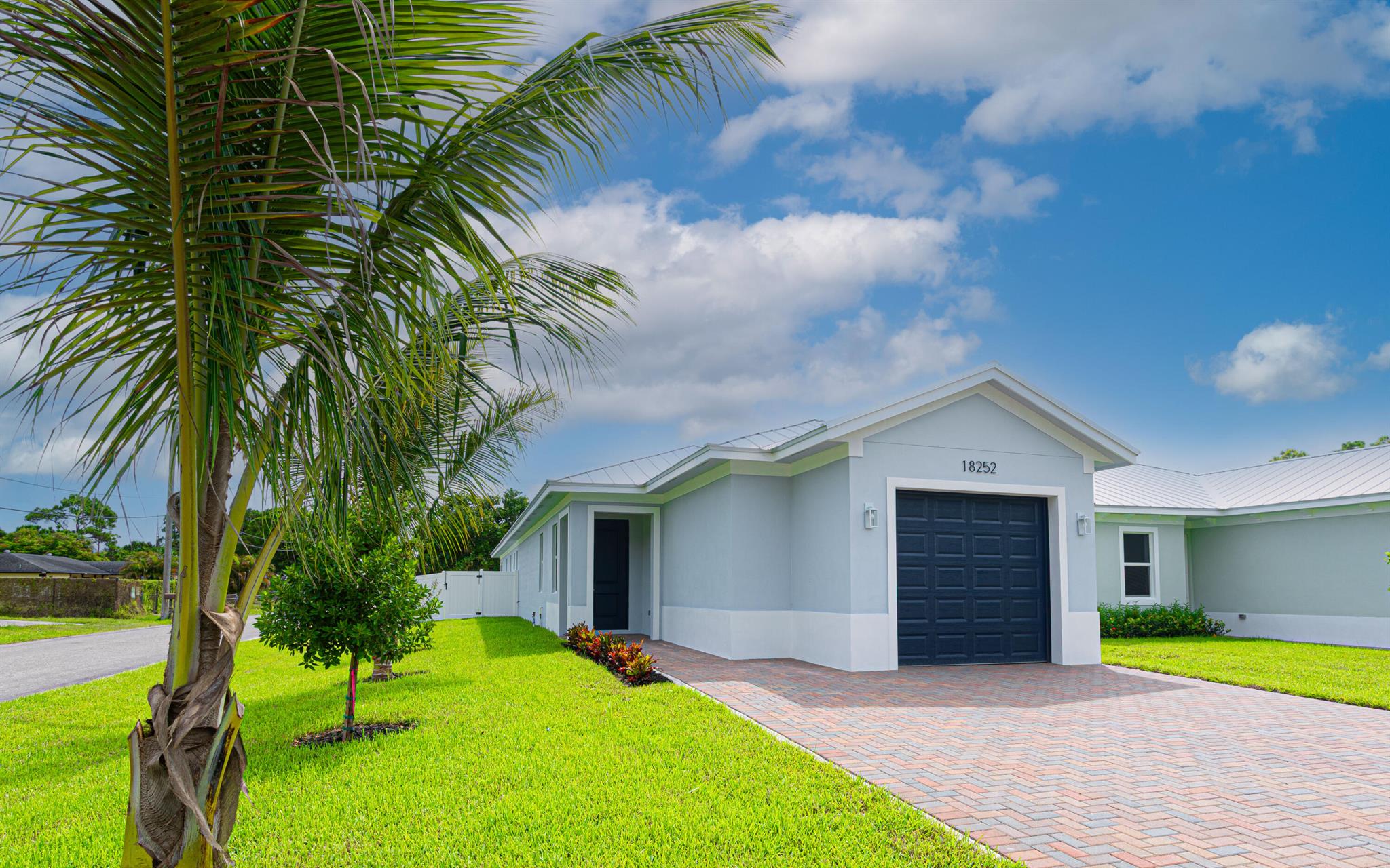 New Construction - 3 Bed, 2 Bath Home in Jupiter's Limestone Creek!This beautifully built home features 3 spacious bedrooms, 2 full baths, and soaring 9.4 ft ceilings with elegant 8 ft interior doors throughout. The open-concept layout showcases a modern kitchen with 42'' upper cabinets, quartz countertops, stainless steel appliances, and a sleek stainless steel range hood.Enjoy ceramic tile flooring throughout, impact-resistant windows and doors, and designer bathrooms with quartz vanities and tile showers. The home also includes an oversized 9' x 21' one-car garage, energy-efficient systems, and a large driveway. Built for style, durability, and low maintenancewith no HOA.Located minutes from top-rated Jupiter schools, beaches, parks, shopping, and easy access to I-95 and Turnpike.