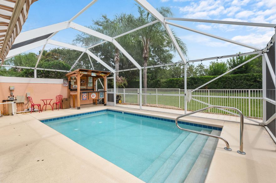 Meticulously maintained pool villa located in the highly desirable The Lakes Tradition community! Beautifully remodeled... this one you'll want to see! Backyard Paradise Included—Enjoy your own private backyard retreat with a screened, heated, saltwater pool, featuring all new pool equipment, a retractable awning, and bar area. Pristine newly paved patio off the pool enclosure with covered grill area, all surrounded by a new fence. Step inside an extended floor plan, 1680 sqft of freshly painted neutral interior featuring stylish new lighting, tile and luxury laminate flooring, and a thoughtfully redesigned kitchen with custom cabinetry, elegant quartz counters, and brand-new SS appliances. 2024 HWH, 2024 W/D, and an Ecowater whole-house purification system. Exterior set to be painted.