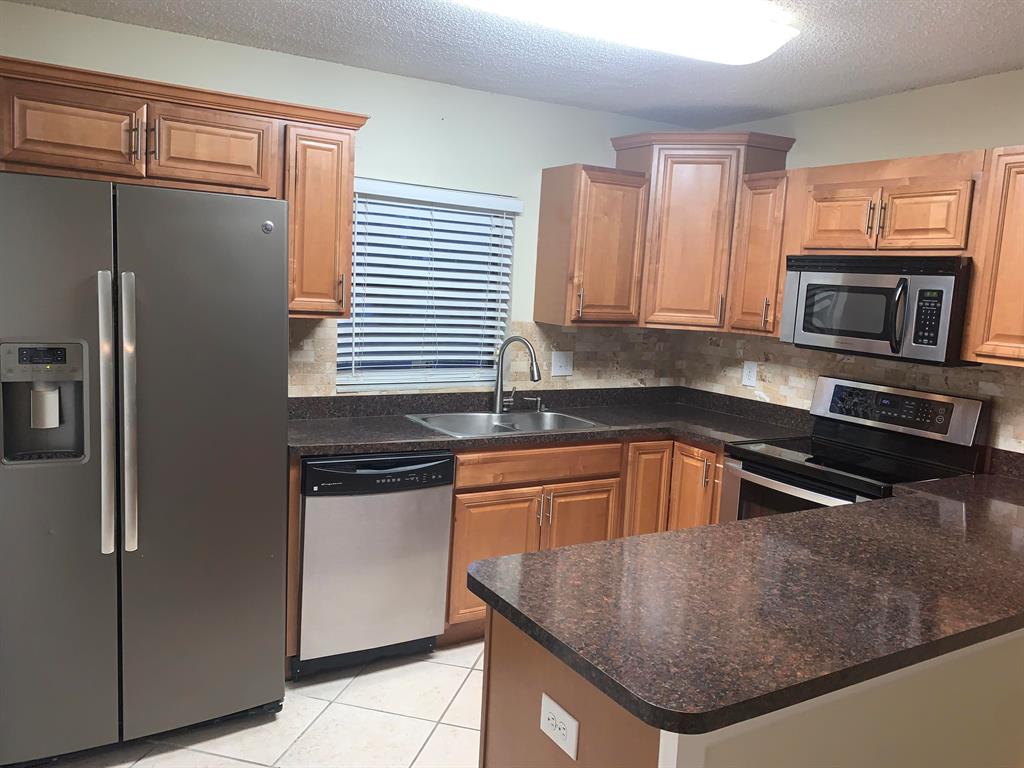 2 spacious bedrooms with large closets 1 1/2 baths with Stainless Steel appliances, deep kitchen double sinks, double sink in upstairs bathroom, 2 dedicated parking spaces with pool nearby. It has a newer roof and AC. Complex is close to US 1, I-95, schools, churches, hospitals, Lawnwood stadium, grocery stores, banks and more.