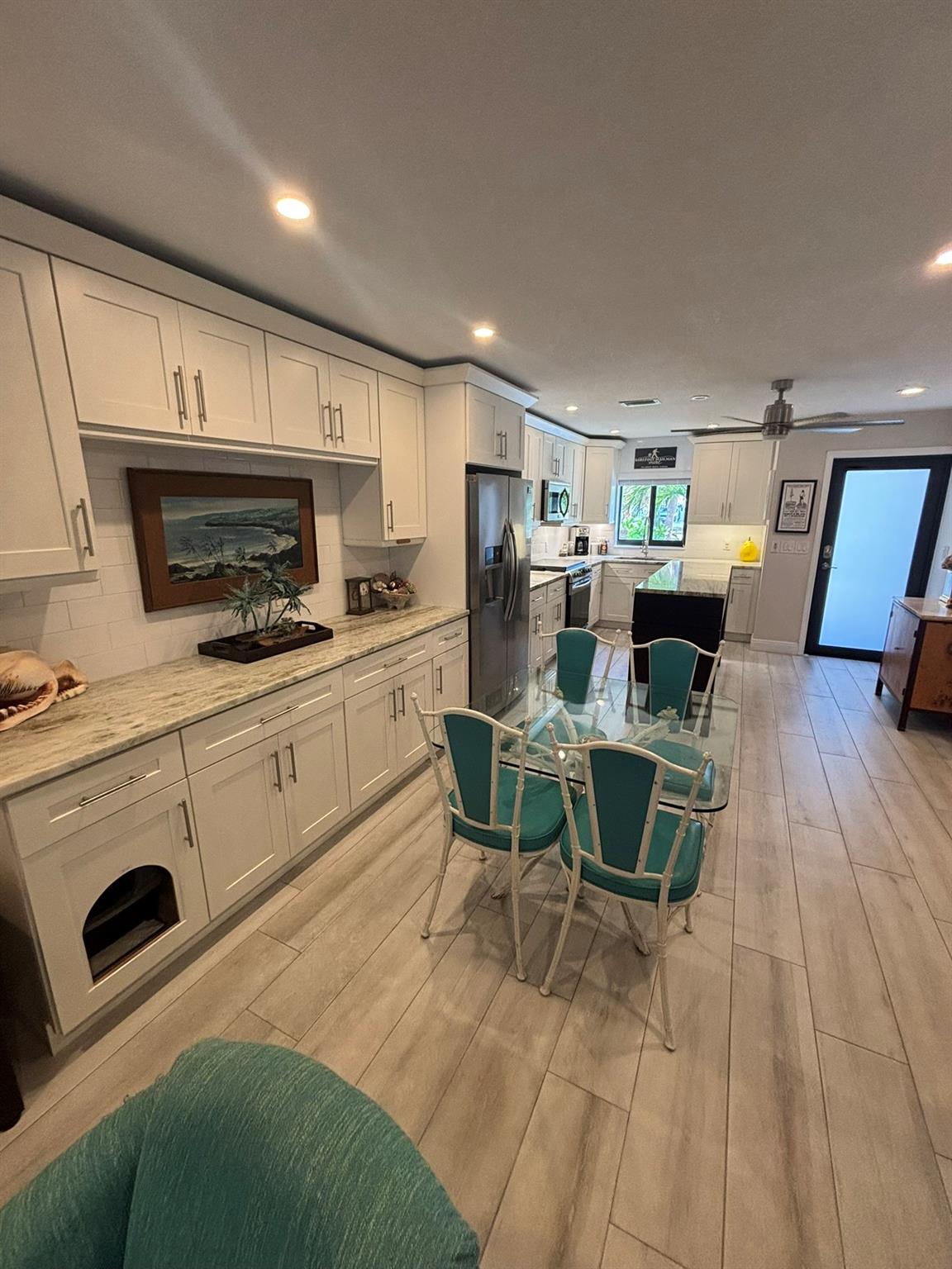 This fully updated townhouse features slow closing shaker cabinets with drawers in the lower cabinets, granite counters throughout, tile floors, and stainless steel appliances. Full hurricane impact windows and doors. Additional window in the family room. A screened in front porch, screened in back patio and balcony off the master bedroom. Three covered parking spots. Three storage closets. Washer and dryer on the second floor. Shared saltwater heated pool. Individual grill area. Roof, A/C, and H/W tank are all 2020. Roof sealed in 2022. It is on a private road with zero traffic. It is conveniently located in front of the Cove Marina and has Intracoastal views. Just steps away from all the shops and restaurants in the Cove Plaza and a very short walk to the beach, pier, and nightlife.