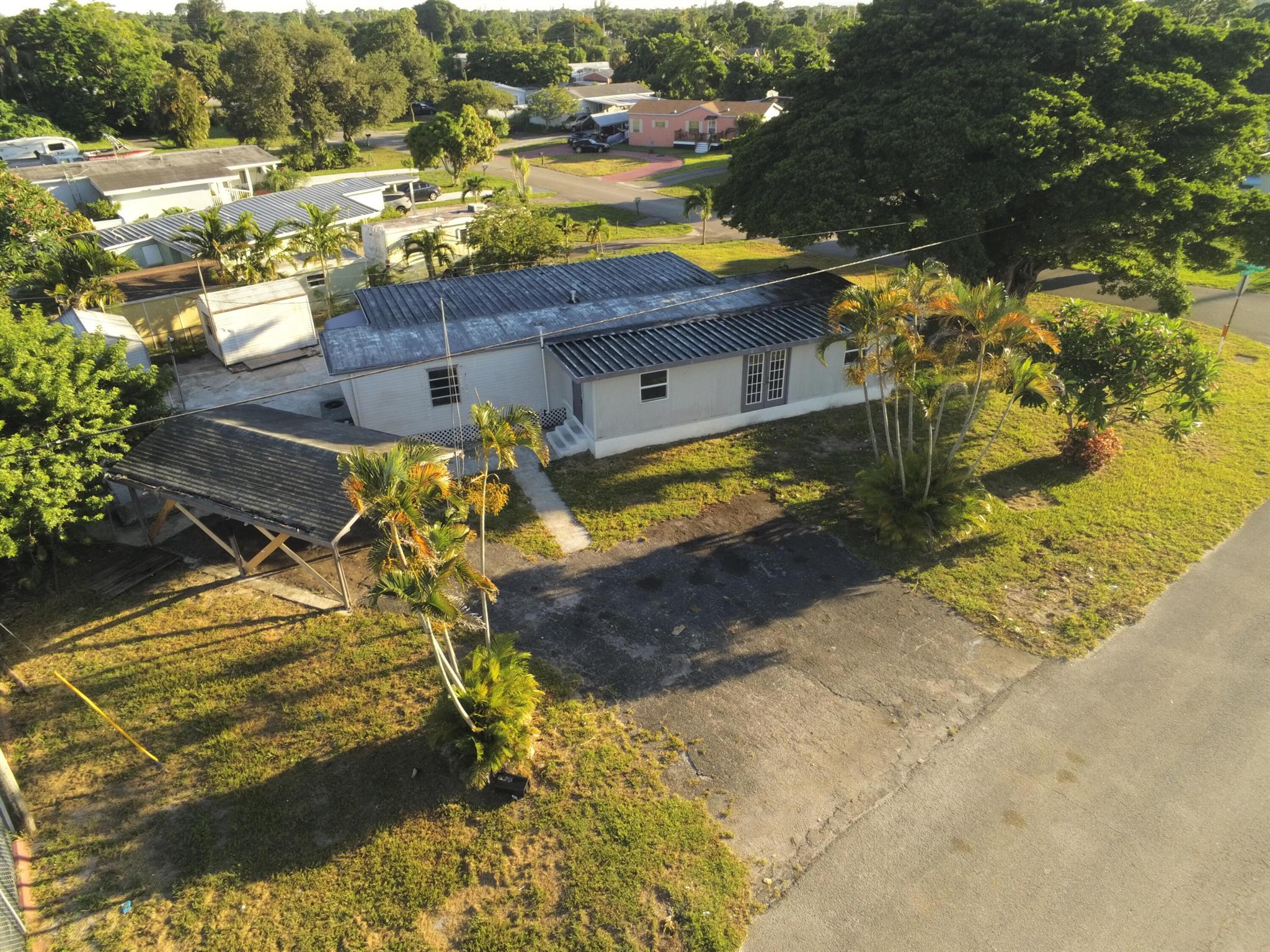 Investor Special - Priced to Sell! This 3-bedroom, 2-bath manufactured home sits on a large corner lot zoned Multi-Family Residential (High Density)--offering plenty of potential whether you're looking to renovate, rent, or build. The home needs significant work, making it perfect for a handyman or investor ready to bring it back to life. For buyers seeking an affordable place to live, this could be a great opportunity to customize and create your own space. The property includes space for all your toys--RV, boat, trailers--and features 2 sheds, a carport, plus easy access to major roads, shopping, and dining. Endless possibilities--live in it, rent it, or rebuild!
