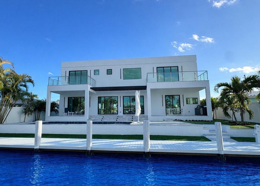 This spectacular never lived in and completed in 2026 new construction 75 ft water frontage home is designed for elegant coastal living. The five bedrooms, five bathrooms, plus a dedicated office/den/bedroom will offer over the top comfort and modern sophistication. Prime waterfront lot built per the 2025 elevation requirements with direct ocean access with no fixed bridges, this property is a boater's paradise. The expansive sliding glass doors invite indoor and outdoor living to an opening to a resort style backyard with a beach entry pool, summer kitchen and water views. A builder warranty is included and the 59-foot boat dock and seawall were fully upgraded in 2025 including a new dockside power​​‌​​​​‌​‌​​​‌‌​​​‌‌‌​​‌​​‌‌​​​​ center.