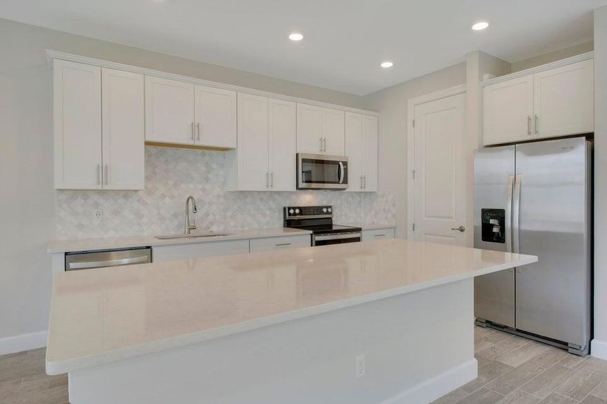 LUXURY 3BRM/2.5BA/2CG TOWNHOME located in OCEAN COVE!  Amazing location just minutes away to the beach & downtown Stuart!  Superior corner unit offers plenty of living space w/tile plank flooring throughout main level & large windows that flood the space with natural light.  Gorgeous kitchen w/white cabinetry plus 42" uppers, large island, quartz counters and stainless appliances. Powder room completes main level. Upstairs you'll find 3 bedrooms including spacious master suite w/walk-in closet and ensuite with dual sinks & walk-in shower w/seamless glass surround. Two additional bedrooms on this level share a guest bathroom complete with dual sinks plus tiled bathtub/shower combo.  Washer/dryer conveniently located upstairs off the loft-style flex area.  IMPACT GLASS! Call today to view!