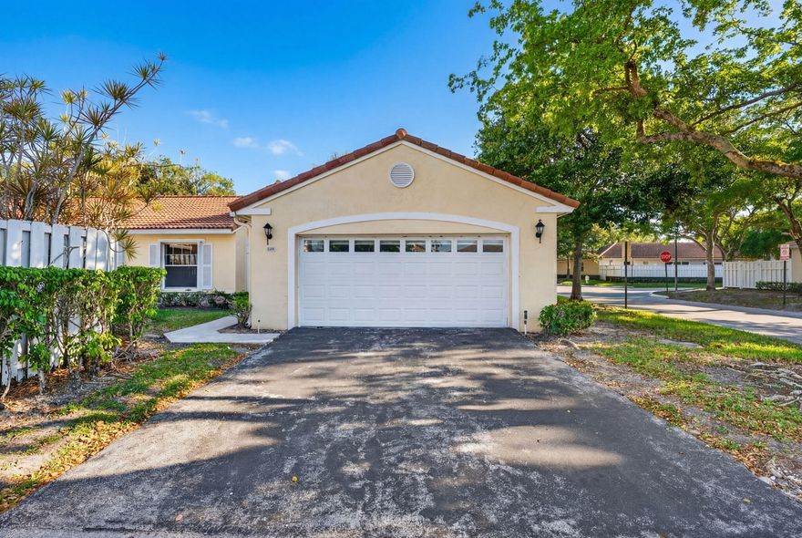 Nestled in a quiet, manicured enclave of Plantation, this stunningly reimagined residence offers an immediate sense of modern elegance the moment you step through its double-door entry. The interior is defined by high ceilings and an expansive floor plan that allows natural light to pour in from every angle, highlighting the sleek, contemporary flooring that runs throughout. Enjoy a 2020 AC, 2022 water heater and newly installed flooring, high hats, and renovated bathrooms! Every corner of the home feels bright and airy, creating a seamless flow between the formal living areas and the more intimate family spaces, making it as perfect for hosting large gatherings as it is for quiet Sunday mornings. At the heart of the home is a cozy kitchen offering a functional layout and a comfortable space for everyday living. Step through the sliding glass doors into a sprawling open patio, all set against a fenced backyard. The backyard offers a rare level of privacy and serenity, providing the ultimate Florida retreat for dining al fresco or lounging in the sun.