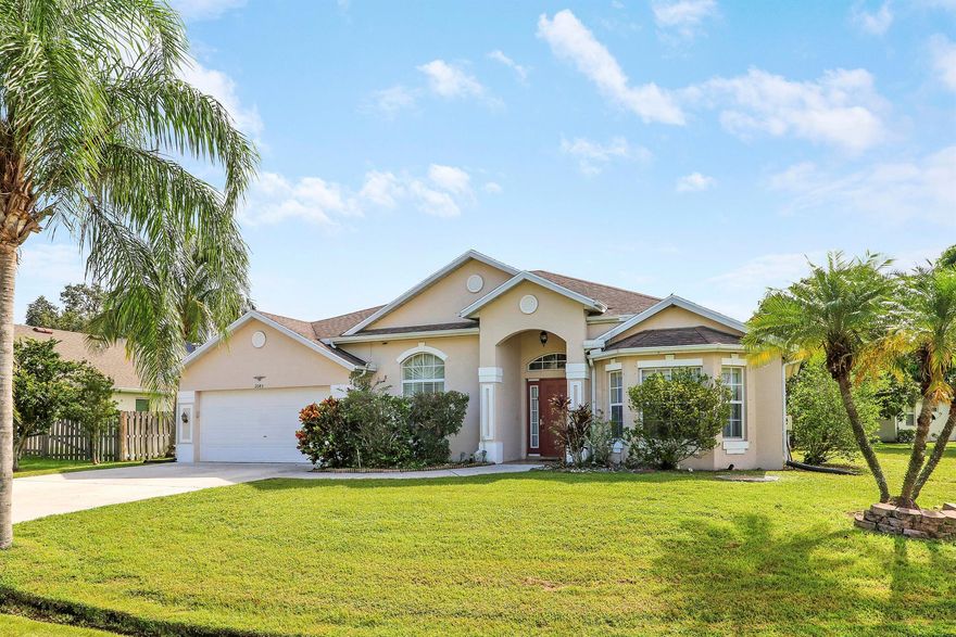 This gorgeous 4bdr/3ba home is impeccably maintained and perfect for entertaining. It is tiled throughout with a spacious formal living room, dining room and office with French doors located just off the foyer. It has a large Family room, breakfast nook with electric fireplace, and a warm inviting kitchen with granite countertops, center island and SS appliances. Enjoy your privacy within a huge covered/screened patio, all with travertine flooring and a summer kitchen with serving counter, gas range cook top, sink and refrigerator. The home enjoys full sprinkler system and mature landscaping as well as full hurricane shutters.  To top it off, a new roof was just installed Sept. 2025!! This home is a must see for buyers looking for a quality built custom home that has it all.