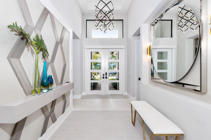 Introducing 9642 Chianti Classico Terr, an exquisite sanctuary where luxury living meets serene lakefront vistas. This magnificent one-story Charleston Grande model is nestled within the prestigious Boca Bridges, promising resort-style living within the comfort of one's community. Encompassing a total area of 5,013 square feet, this remarkable property boasts an approximate interior space of 3,947 square feet. Offering five bedrooms and five full bathrooms, it provides ample room for comfortable living and luxurious accommodation. Enter inside to discover exquisite limestone flooring that sets the tone for elegance throughout. This is not just a home; it's a smart home, equipped with the latest technology to elevate your lifestyle.