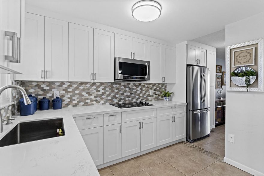 Over $40,000 in upgrades!  Enjoy this RENOVATED OPEN CONCEPT , 1st FLOOR & CORNER condo with DOUBLE LAKE views and FULL IMPACT WINDOWS w/ premium & motorized blinds.  This 2 bedroom, 2 bath has 2 large closets. The expanded kitchen has white shaker wood cabinets, S/S appliances and stunning white quartz countertops with room for a small eat in area. Relax on the SUNNY PATIO and take in the peaceful water views. Just 12 miles to the beach and near the Sawgrass Mall. Close distance to the satellite pool, tennis & pickleball courts. Parking #28 is in front of unit+ storage in 3rd floor.  The main clubhouse has theater, pool, gym, tennis, BBQ area, clubs, activities & more.  ALL RESIDENTS & OCCUPANTS IN THIS PHASE 3/BLDG #78 MUST BE OVER 55+.