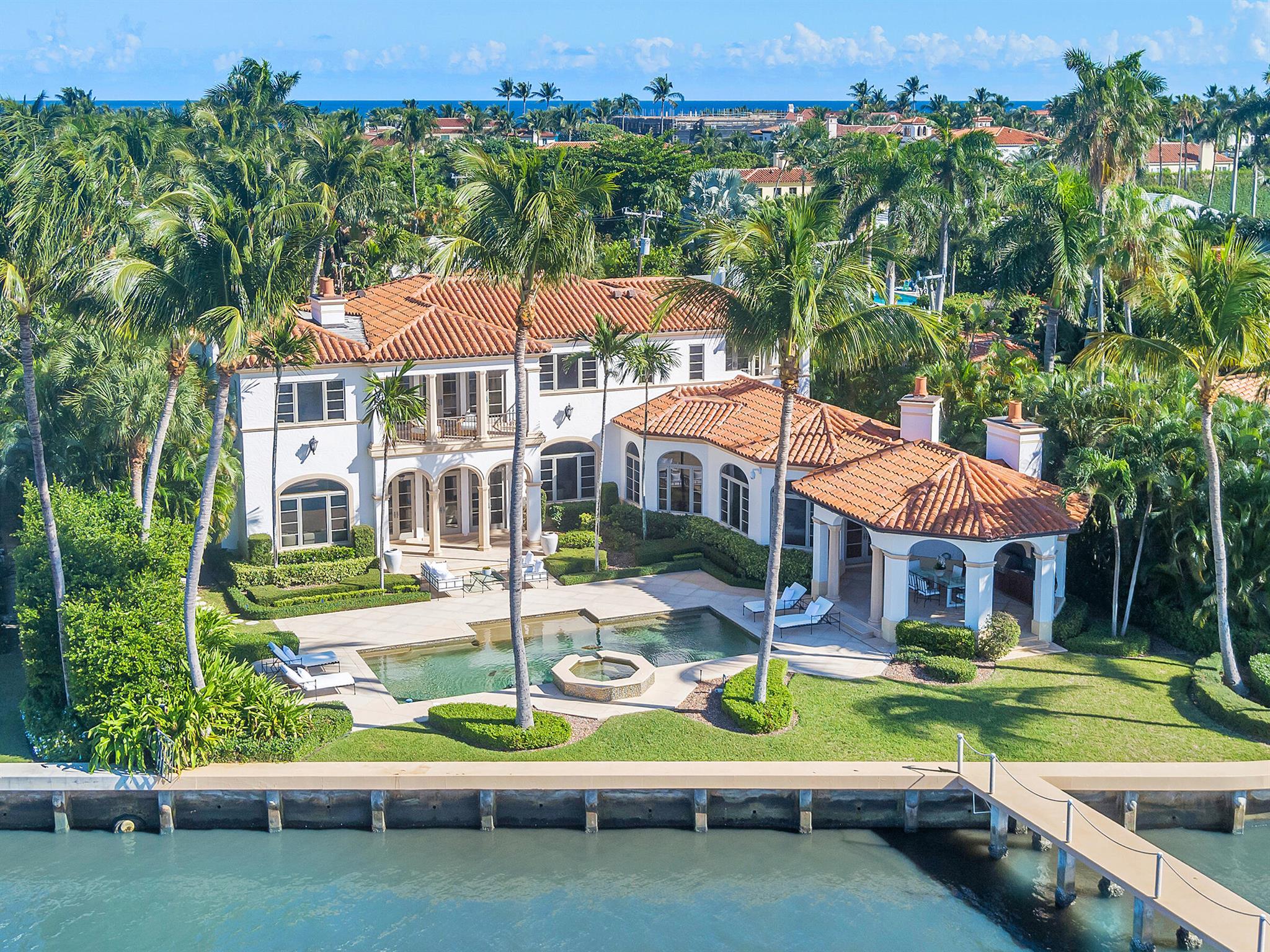 Water, Water Everywhere from the moment you walk in to this magnificent direct lakefront Mediterranean estate on over 2/3 of an acre located in the exclusive Estate Section of Palm Beach. Gated and lushly landscaped, the property is surrounded by mature foliage providing maximum privacy before opening up to 117' of commanding Intracoastal views. The gracious floor plan offers 5 bedrooms/7.5 baths and volume ceilings throughout. Highlights include luxurious second floor primary suite with private balcony and sitting room, chef's kitchen with butler's pantry, wood paneled library, oversized family room, wine cellar, media room, elevator, 100' x 40' concrete dock, full house generator and 3 car garage. Fabulous outdoor spaces with grand covered loggia ideal for dining and entertaining.