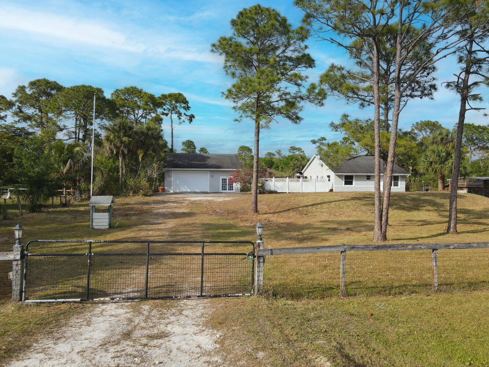 DETACHED GARAGE/WORKSHOP. Presenting 17851 68th St N, a great 3-bedroom, 2-bathroom home offering 2,142 Sq Ft of living space sitting on a spacious 1.14-ACRE fenced lot. Located in the peaceful community of Loxahatchee, this property is just down the street from local schools and conveniently close to shopping, dining, and other amenities. Inside, you'll find a partially remodeled home with modern features and finishes throughout. The kitchen has newer cabinets, sleek countertops, and a farm sink. Both bathrooms have been fully updated with beautiful tile and modern finishes. Additionally, the home features a versatile bedroom, which can easily serve as a guest room, office, or hobby space. The property also includes a LARGE DETACHED GARAGE that can be used as a WORKSHOP