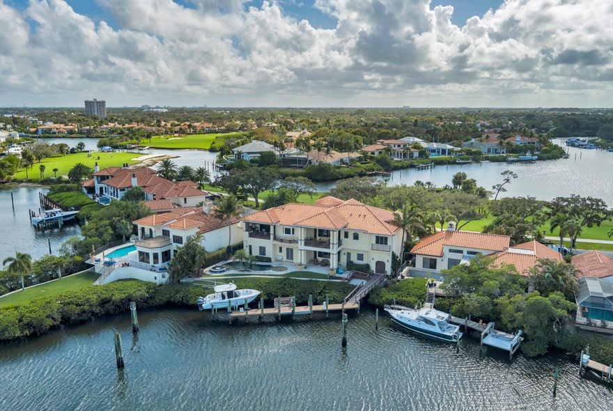 Stunning Intracoastal Estate with 100 Foot Dock in Gated Jonathan's Landing
Perfectly positioned within the prestigious gated community of Jonathan's Landing, this extraordinary waterfront estate offers over 6,185 square feet of luxurious living space and showcases some of the most breathtaking views in the community. From sweeping vistas of the Intracoastal Waterway, to a tranquil canal setting and private preserve island, the home delivers an unmatched waterfront lifestyle.
What truly sets this property apart is the rarity of two spectacular and distant view corridors. The rear of the home captures panoramic water views of the Intracoastal, canal, and private preserve island, while the entrance side of the property enjoys sweeping golf course, marina, and stunning sunset views a combination seldom found in Jonathan's Landing. Rarely does a property offer two such dramatic vistas in completely different directions.
Designed for the most discerning buyer, this residence is widely regarded as one of the finest constructed homes ever built in Jonathan's Landing, where no detail was overlooked and no expense spared. Architectural elegance is evident throughout, beginning with the grand turret-style entrance, soaring ceilings on both levels, intricate ceiling treatments, and beautiful crown molding that frame the home's refined interior.
The thoughtfully designed floor plan features 4 spacious bedrooms, 5 full bathrooms, and 2 half baths, with all bedrooms offering private ensuite baths. Two dedicated home offices provide flexibility for work or study, while expansive living and entertaining spaces flow seamlessly throughout the home.
At the heart of the residence is a massive chef-inspired gourmet kitchen, perfectly designed for both everyday living and entertaining. A private bar adds another element of sophistication, making this home ideal for hosting family and guests.
The primary suite is truly exceptional, highlighted by an enormous custom walk-in closet and luxurious spa-like bath. Throughout the home, beautiful marble flooring and high-end finishes further emphasize the superior craftsmanship.
Step outside to experience true South Florida waterfront living. The property features a spectacular pool and spa, complemented by a summer kitchen and outdoor entertaining area perfectly positioned to capture the stunning water views.
For boating enthusiasts, this property is a true boater's paradise. The private dock offers space for two vessels, including accommodations for a yacht up to 100 feet, plus a boat lift for a second vessel--an incredibly rare feature in the community. The property location provides exceptional access to the ICW and nearby Jupiter inlet.
Additional highlights include a full-house generator, a large two-car garage plus tandem garage with rear waterfront access, and impeccable construction quality throughout.
Waterfront homes of this caliber rarely become available. Offering the perfect combination of location, views, boating access, and exceptional craftsmanship, this is a truly special opportunity within Jonathan's Landing.
