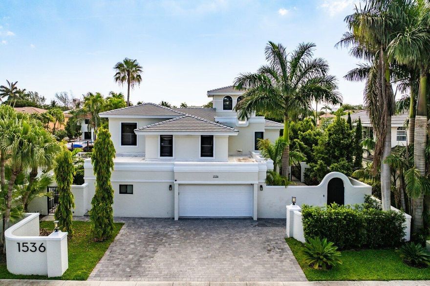 Enjoy Luxury Waterfront living in this Mediterranean Estate home in East Boca Raton. This extraordinary fully renovated 4/4 home features a new roof & impact windows & doors. Walk thru the lushly landscaped private courtyard and as you enter the home you will immediately notice the natural light streaming in, the 2 story living room ceiling & the expansive water views. This home is made for entertaining with a fantastic new wet bar complete w/a built in wine cooler & ice maker & the all white eat in kitchen w/ gorgeous quartz counter tops and bar & new highly upgraded Monogram kitchen appliances. As you step out to the oversized pool & patio you can imagine using your summer kitchen under the pergola & docking your boat at your own private 70 ft. dock.