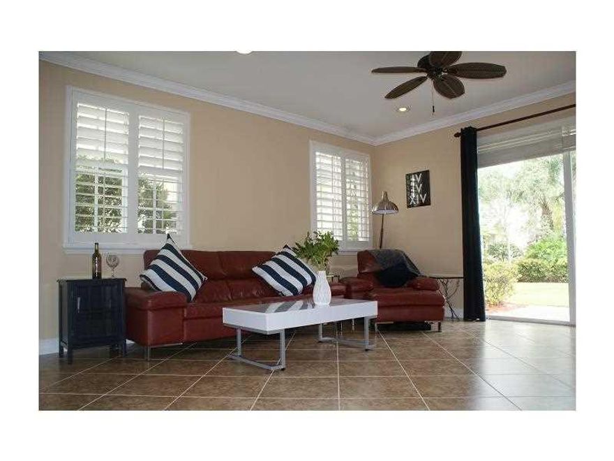 Barley lived in 2010,3brm2.1ba 2car/truck garage in heart of Davie. Corner home has extra impact glass/doors to allow natural light & garden views. Oversized stone floors down & Mahogany wood look up stairs. All bathrooms & kitchen have granite counters.  Stainless appliances,   All closets have custom built-ins. Master has 3 closets!! Plantation shutters, crown molding. Easy access to highways, beaches, airports. $145maint includes exterior ins. Pool, Tot lot. Ask 4 full list of upgrades! Move-in-ready