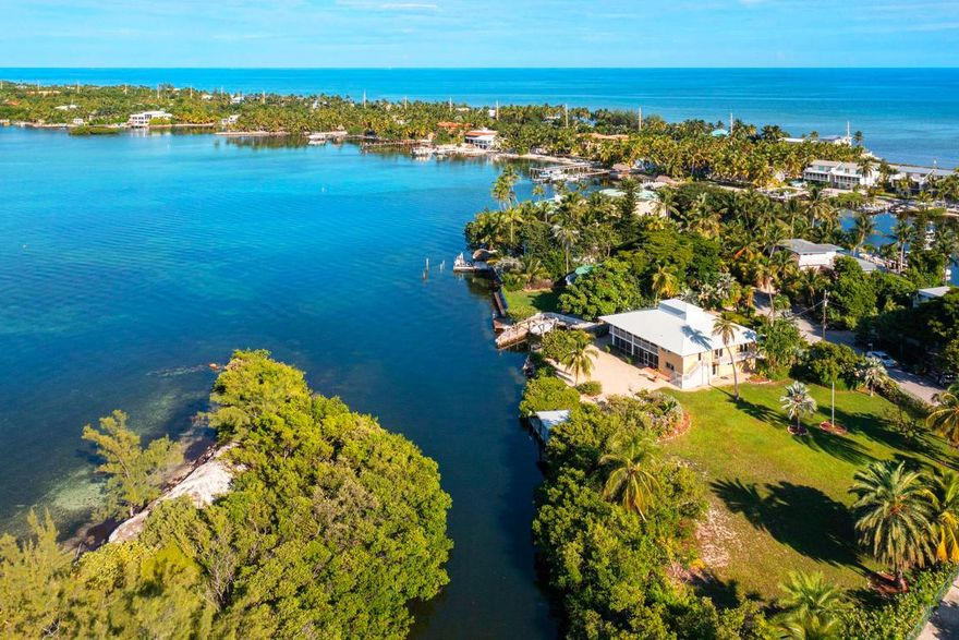 It is located on Lower Matecumbe Key and is strategically situated in one of the most respected and prestigious neighborhoods of Islamorada. Since this one-of-a-kind property has not been on the market since 1967, it is an exceptional find. With an outstanding and spectacular view of the Florida Bay, it is positioned at the mouth of the canal, which offers protection from wind and erosion, with deep-water access. The façade of this home has recently been remodeled and completely updated with impact doors, windows, and concrete board siding. It features a beautiful deck ashore a tranquil canal that is full of life. Enjoy your afternoon watching wildlife at your doorstep. Boaters have easy ocean access through Channel 2 Bridge. Spectacular views of the Florida Bay with new siding & hurricane impact windows, deep-water access 260' on the water w/dock & boat slip Vaulted ceilings Downstairs open recreation room 2 car garage Adjoining lot 188' x 129".

There are two (technically three) bedrooms and two full baths upstairs, with a large walk-in closet in the Master Bedroom and a large screened-in porch. The downstairs boasts a large recreational room with a full bath and an unfinished bedroom. The house is situated in such a way that there is a Bay view from the kitchen, living area, and master bedroom. There is a screened-in porch downstairs as well as two one-car garages with room on the lot for 11 cars to park comfortably. 
As an option, the property features a massive 35066 sq. ft. plot of land with perfectly manicured gardens that are perfect for entertaining that can be sold separately. The adjoining lot is NOT offered with the house but can be sold separately. It is buildable and a beautiful swimming pool or tennis court can be built on it. With hardly any land in the Florida Keys, this is an exceptional treasure. The two lots combined have 260' on the water with a dock and boat slip. The extra lot is 0.42 acres or 188' deep x 129' wide. This lot is a must have. It is simply too perfect for its location. There is plenty of room for a guest house, pool, and tennis court.