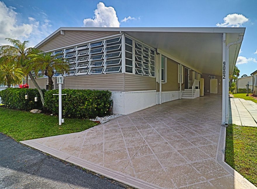 This One of a Kind Home which is beautifully maintained 3 bedroom / 2 bath home, features gorgeous 3/4" hardwood flooring throughout the entire home, large spacious kitchen with white cabinets,  large dining area for entertaining, living room plus an open den, walk -out directly into the Great/FL room with A/C, all on one level which provides a wonderful additional living space.  Large Master bedroom with ensuite walk-in shower, 2 additional bedrooms and full size bathroom.  New A/C 2025, Brand new  stainless steel appliances in kitchen, Inside separate washer & dryer room with Brand new washer & dryer.  Large attached shed with work bench and shelving, Golf Cart Pad, outdoor porch and working lift.  Driveway for 3 vehicles.  This truly gives you the feeling of living in a large home.  CASH PURCHASE ONLY - 55 Plus Gated Community NO LOT RENT MONTHLY HOA VERY LOW $270 PER MONTH - NO LEASING  - Generator for the entire house, Irrigation around entire house.  Accordion Shutters around entire house, security system,  Community offers many social events, amenities, pools, bocci ball, shuffleboard, pickleball, and so much more.  Close to shopping and many restaurants. Very low HOA fee which include water/sewer/trash/ lawn service/ full time manager, high speed fiber optic wi fi - Move in READY Bring your suitcase.