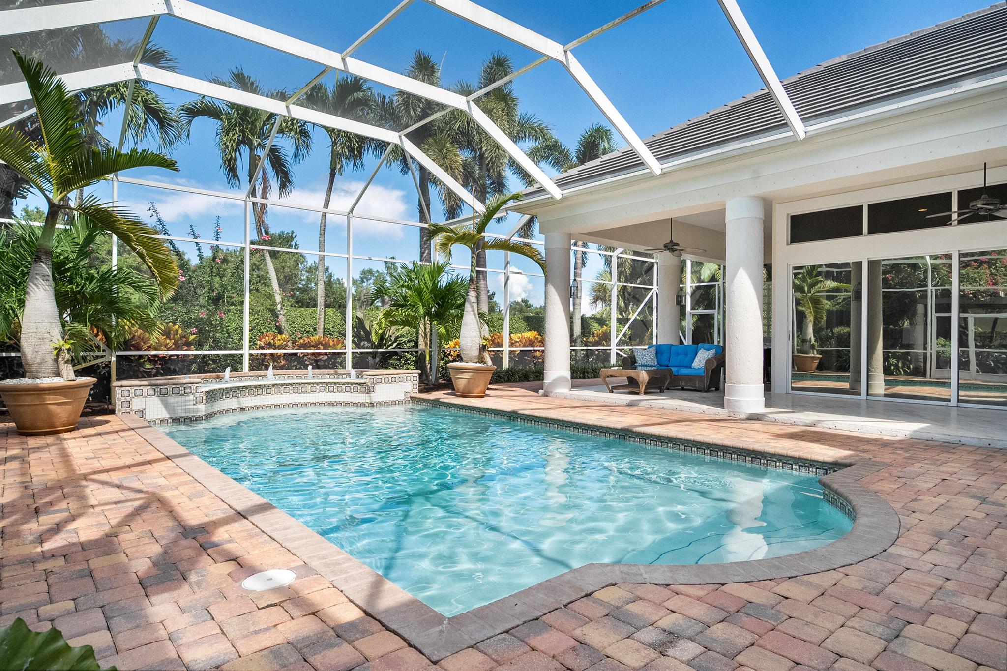 ONE-OF-A-KIND CUSTOM POOL HOME IN PALM COVE! Steps from the Riverfront clubhouse & 93-slip marina w/direct ocean access, this elegant 3,300 sq. ft. home offers the ultimate Florida lifestyle. Beautifully updated w/new roof, soaring volume ceilings and walls of glass that invite natural light & lush garden views. Expansive sliders open to a private screened-in pool oasis, complete w/a built-in summer kitchen and serene tropical landscaping. Perfect for entertaining or relaxing in style. The chef-inspired kitchen features custom cabinetry, quartz countertops, a beverage fridge, and a sunny breakfast nook. Additional highlights two luxuriously updated bathrooms, stunning stone floors, rich custom millwork, a dramatic floor-to-ceiling fireplace & golf cart garage.