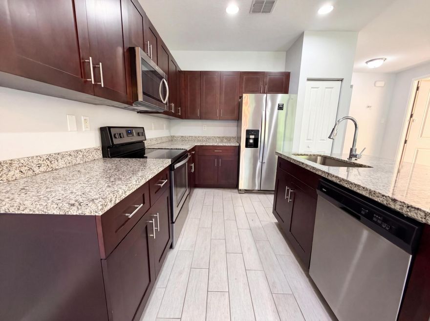 Come see 5213 NW 50th Ter, a residence designed for everyday practicality and comfort. The kitchen includes all stainless steel appliances and a functional island. The primary bathroom features double sinks and a separate tub and shower. The primary bedroom has a walk in closet. A patio extends the living space. This comfortable, functional design is a must-see.. Included 100-Day Home Warranty with buyer activation