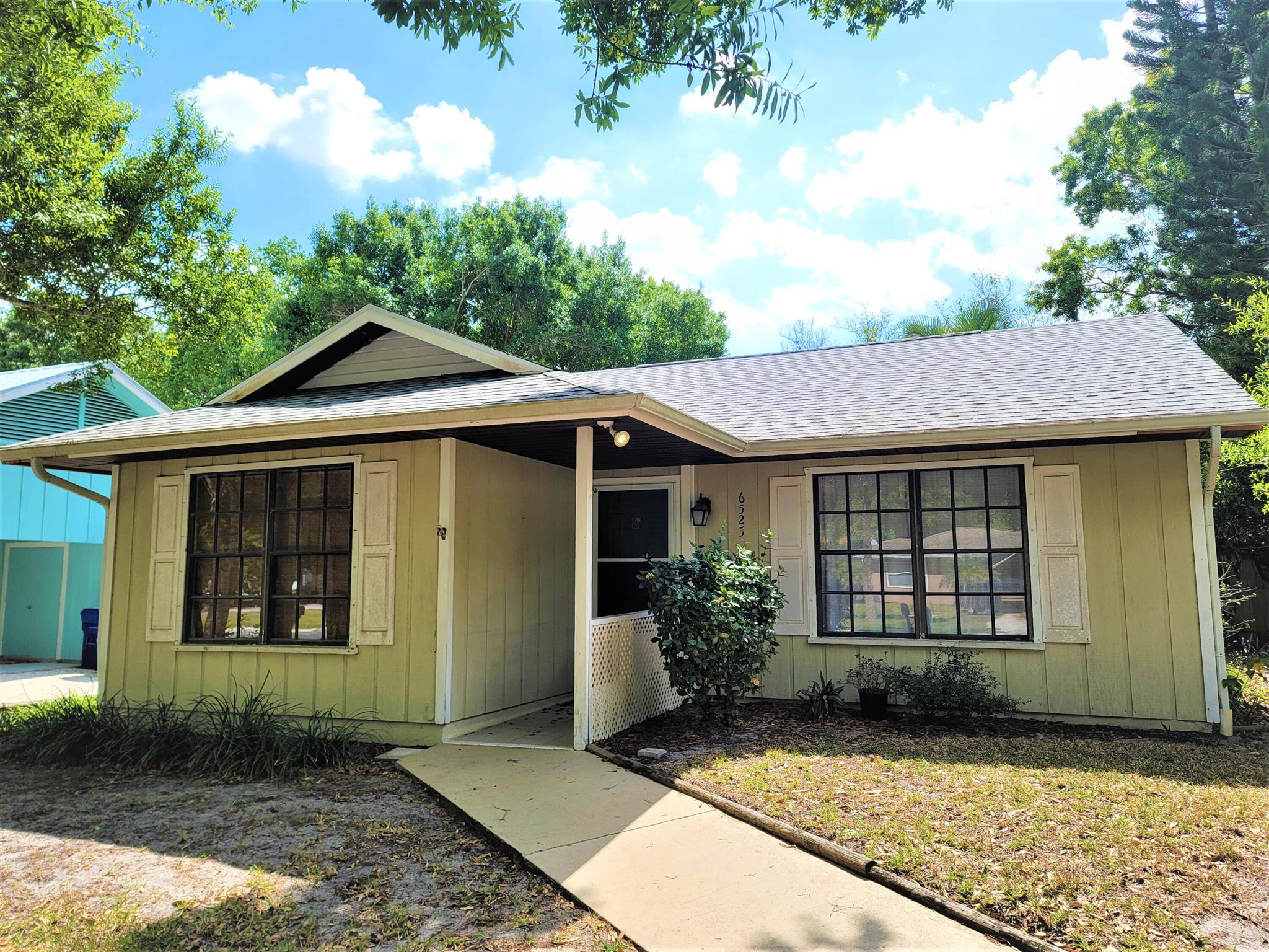 Available now, unfurnished annual rental. Cute as a button, with lots of natural light, spacious 2/1 home, with bonus room Florida room. Covered front porch and Patio in the back of Florida room. Open floor plan. Living, dining room and kitchen combo. Kitchen with mobile island and lots of cabinet and countertop space. Laminate flooring in living areas. Florida room has tile flooring and beautiful woodwork on ceiling. Located In Pine Tree Park Vero Beach, Florida, close to all the major shopping and just few minutes away from sunny beaches, medical, theater, art museum. Landscaping and pest control included in the monthly rent. Room sizes are approximate.