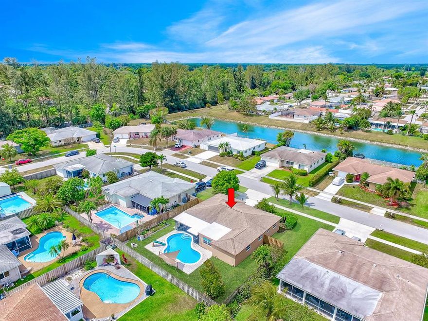 Spacious & open 3 bedroom plus a big playroom/bonus space/den (could be 4th bedroom), 2 bath, 2 car garage, huge backyard with covered & screened in patio with a huge sparkling swimming POOL! High end laminate wood flooring throughout. Newer windows/some are impact/all have shutters as well. Huge kitchen features tons of cabinets and counter space plus a sunny eat in area. A formal living room and big living room plus a large bonus room. Large bonus room makes a great family/Florida room, playroom, man cave, office, gym etc. Move in Ready! Guest bath is updated and has a large bathtub(bigger and deeper than the normal tubs). A tropical paradise awaits you outside featuring a huge fenced in yard with mature trees including mango, guava, loquat, bananas and jackfruit. A great place to relax on a hammock as well as a great place to entertain. Kidney shaped pool w/new pool pump and motor Plus has kiddie fence! Screened in covered patio. Tons of green grassy area. Fenced in yard. Roof from 2006/hurricane rated garage door/Hurricane protection for all openings. Sprinkler system. Great Schools! Just a short walk to the Elementary school. Low HOA fee of only $34 a month! No clubs to join. Pets ok. FHA & VA loans ok! All ages! Attention Investors: You can rent right after purchase.