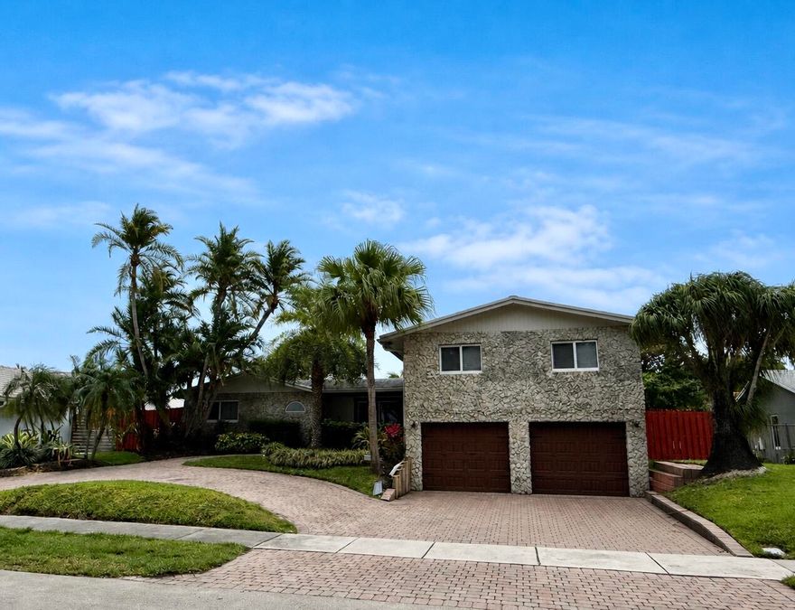 Welcome to 1232 NW 14th Street, a rare luxury home in Boca Raton, Florida offering space, style, and an unbeatable location. This 4-bedroom, 4-bathroom pool home in Boca Raton features a desirable two-story split floor plan, perfect for privacy, flexibility, and modern family living. Designed with both comfort and entertaining in mind, the home showcases a custom chef's kitchen with oversized island, premium Sub-Zero refrigerator and freezer, and high-end finishes throughout. A built-in bar enhances the living space, creating the ideal setting for hosting and everyday enjoyment. Step outside to your private South Florida oasis featuring a resort-style pool, covered pergola, and fully equipped outdoor summer kitchen with barbecue which is perfect for outdoor living in Boca Raton.  This home is ideally situated within walking distance to A-rated Boca Raton schools and just minutes from Florida Atlantic University, making it highly desirable for families and investors alike. Enjoy close proximity to top Boca Raton shopping, dining, parks, and beaches, with easy access to major highways. If you're searching for a Boca Raton luxury pool home or a 4-bedroom home near FAU, this property checks every box. Homes with this level of space, upgrades, and location are a rare find in Boca Raton real estate.  Schedule your private showing today and experience one of the best values in Boca Raton luxury real estate.