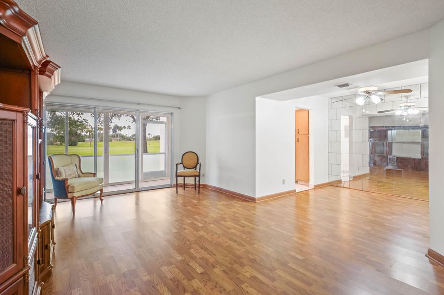 WELCOME TO THIS CONVENIENT GOLF FRONT CONDO!  LIFE IS A BIT EASIER  WITH PARKING IN FRONT OF YOUR FIRST FLOOR HOME.  THIS POPULAR FLOOR PLAN INCLUDES A 24' GLASSED & SCREENED PATIO THAT OPENS INTO THE EAT-IN KITCHEN, LIVING ROOM & THE MASTER BEDROOM WITH ITS 2 CLOSETS (1 IS A WALK-IN) & UPDATED WALK-IN SHOWER.  A SPLIT BEDROOM PLAN GIVES YOUR GUESTS A MURPHY BED (GIVING YOU SPACE FOR USE WHEN A BED IS NOT NEEDED) & AN ADJACENT FULL BATH WITH A WALK-IN "SAFE STEP" TUB. THIS HOME HAS BEEN PAINTED,HAS A NEW ELECTRIC PANEL, WELL SERVICED TRANE A.C. UNIT, 2019 WATER HEATER & IS IN A BUILDING WITH A NEW ROOF & PAINT.  THE SUBDIVISION POOL IS NEARBY.  USE AN ADDITIONAL POOL AT THE CLUBHOUSE WITH ITS PICKLEBALL, TENNIS, PAY-AS-YOU-PLAY GOLF, GYM & MEL'S BISTRO. PRICED FOR YOU TO MAKE YOUR OWN!!