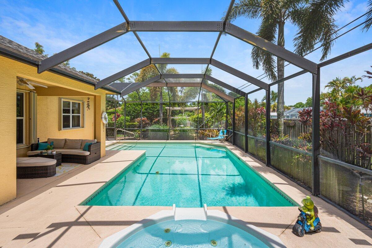 Spacious 4BR/2BA pool home just 2 miles from I-95, 7 minutes to Tradition, and 5 minutes to St. Lucie West dining. Enjoy rare privacy with no immediate side neighbors, soaring 12-ft ceilings, and a split floor plan offering both comfort and quiet. The kitchen, with it's SS appliances, opens up to the living area which overlooks the large saltwater pool and spa, perfect for relaxing or entertaining. The covered patio features multiple ceiling fans to keep things cool while you grill out or host friends. Thoughtfully designed for everyday living with room to breathe, unwind, and feel at home. A true retreat in a prime location!