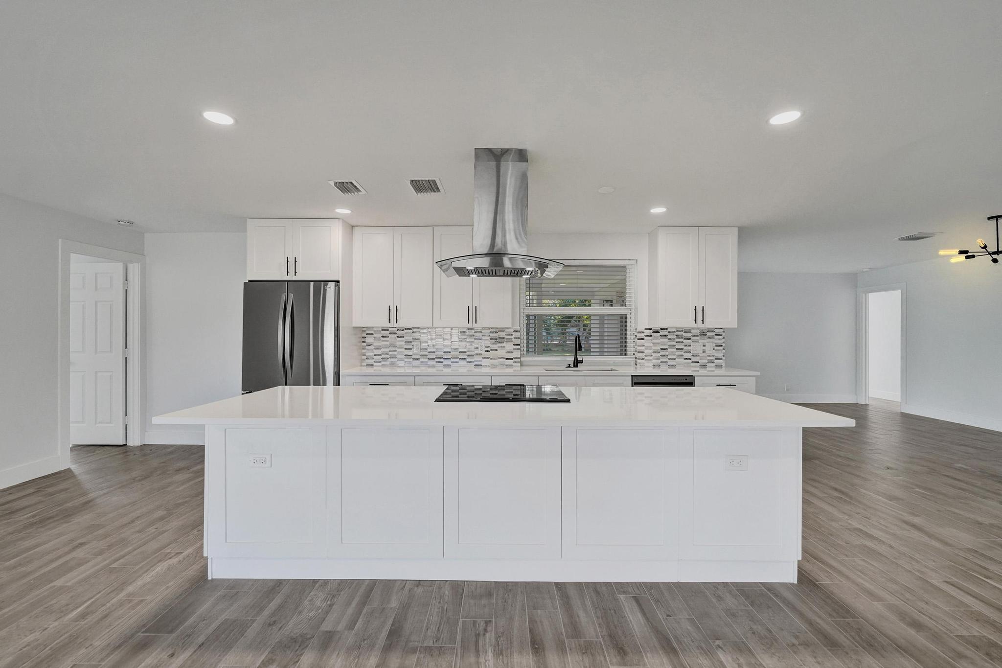 **Fully renovated and move-in ready perfection** This stunning 3-bed, 2-bath home in sought-after North Plantation Acres features an open layout with designer touches throughout—sleek quartz counters, brand-new cabinets, and premium stainless steel appliances. ALL NEW, 2023 roof, impact windows/doors, A/C, electrical, LED lighting offer modern comfort and peace of mind. Both baths shine with spa-style tile, frameless glass showers, and quartz vanities. Beautiful wood-look porcelain floors, modern fans, blinds complete the look. Enjoy a huge ¼-acre lot with a private yard, covered porch, and room for a pool. No HOA, 2-car garage, and prime location near parks, shops, dining, and major highways! Virtual pool/furnishings for inspiration.