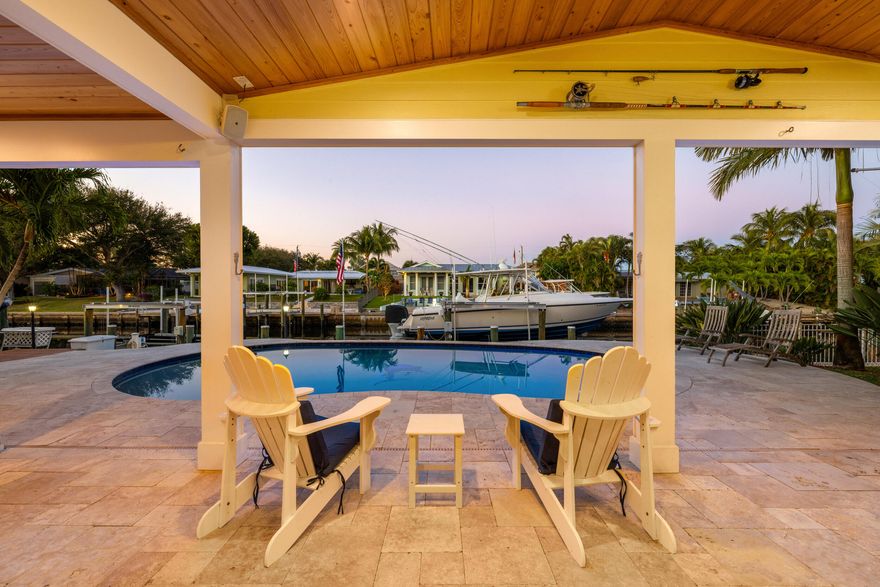 Set along a deep-water canal on a quiet cul-de-sac within one of North Palm Beach's most established, family-friendly streets, this waterfront residence reflects a calm, considered approach to coastal living one that values both refinement and function. With 80 feet of seawall, a decked-over dock, and two boat lifts rated at 16,000 and 12,000 pounds, the property offers seamless access to open water and a lifestyle shaped by time spent outdoors. Inside, light-filled interiors unfold through an open layout that maintains a constant visual connection to the water. The 2024 kitchen is intentionally curated, finished with quartzite countertops, a gas cooktop, wall oven, and new stainless-steel appliances, balancing everyday usability with elegance. The oversized primary suite is set apart as a private retreat, offering dual walk-in closets and a spa-style bath with a two-person Jacuzzi tub, double shower, and dual vanities. Two additional bedrooms with hardwood floors provide flexibility for guests or home office use. A generous family room, anchored by a gas fireplace and a built-in wet bar with beverage refrigerator and quartzite countertops, opens through a full three-panel slider to an oversized, vaulted-ceiling covered patio and expansive paver pool terrace. Outdoors, a custom 2014 pool equipped with an air chiller overlooks the deep-water canal, creating a seamless indoor-outdoor setting well suited for entertaining. Recent updates include a new roof (2024), gas water heater (2025), plantation shutters, crown molding, and solid-core doors, resulting in an enduring expression of modern coastal living.