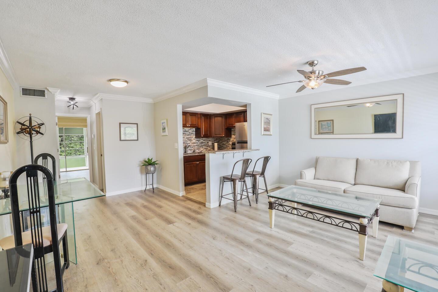 Charming 1 bed, 1.5 bath condo in the heart of Stuart, FL--just minutes from downtown, beaches, and golfing. Enjoy a stylish kitchen with granite countertops, a beautiful backsplash, and stainless steel appliances, freshly painted this year. New luxury vinyl and tile flooring throughout. Relax on the covered balcony patio off the owner's suite. Grab a towel as this unit is close to the pool, and enjoy other community amenities such as shuffleboard, clubhouse, and more! Laundry/storage is also conveniently next door. Partially furnished. With a NEW AC unit and community maintained roof and exterior, it is easy Florida living!