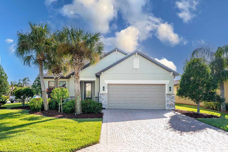 EXCELLENT PRICE AND EASY TO SHOW! Stunning move in ready 3/3 + Den is everything you want! With its impeccable design, this home offers open concept living & welcoming spaces. Many of the upgrades include quartz countertops, custom glass & Carrerra marble backsplash, large pantry & butlers pantry w/wine fridge, upgraded tile & vinyl wood planking floors throughout, custom Wainscoting features & crown molding, upgraded lighting & fans, built in fireplace, freshly painted walls, newer AC's 2022, extended patio, COMPLETE impact glass, oversized garage, upgraded landscaping & outdoor lighting and all of this in a lovely community with first-class amenities! This gorgeous home is walking distance to Publix, restaurants, nail salon, etc. and close to the turnpike and I-95.