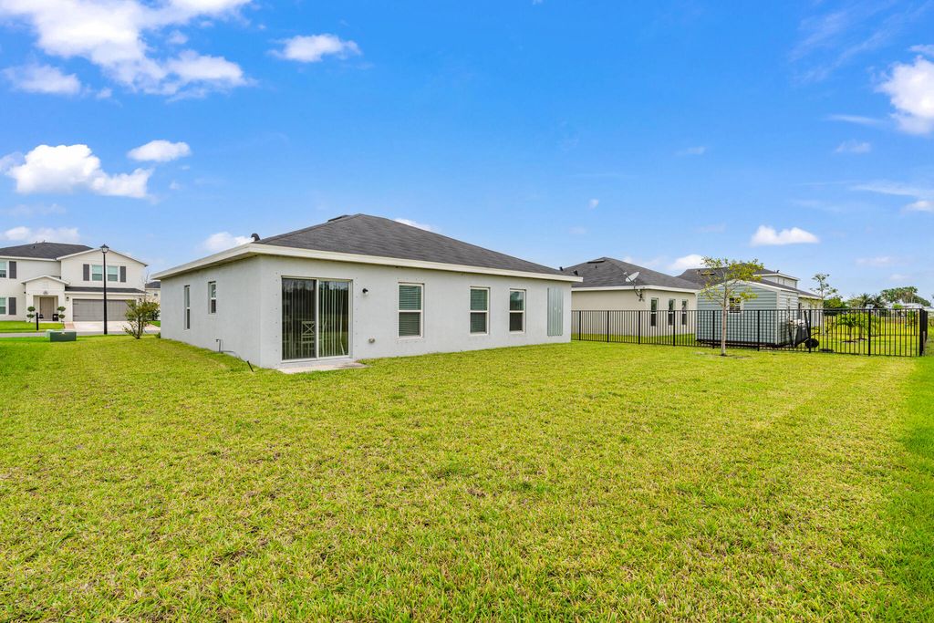 Photo of 177 Dabou Loop, Belle Glade, FL 33430 (MLS # B26005323)