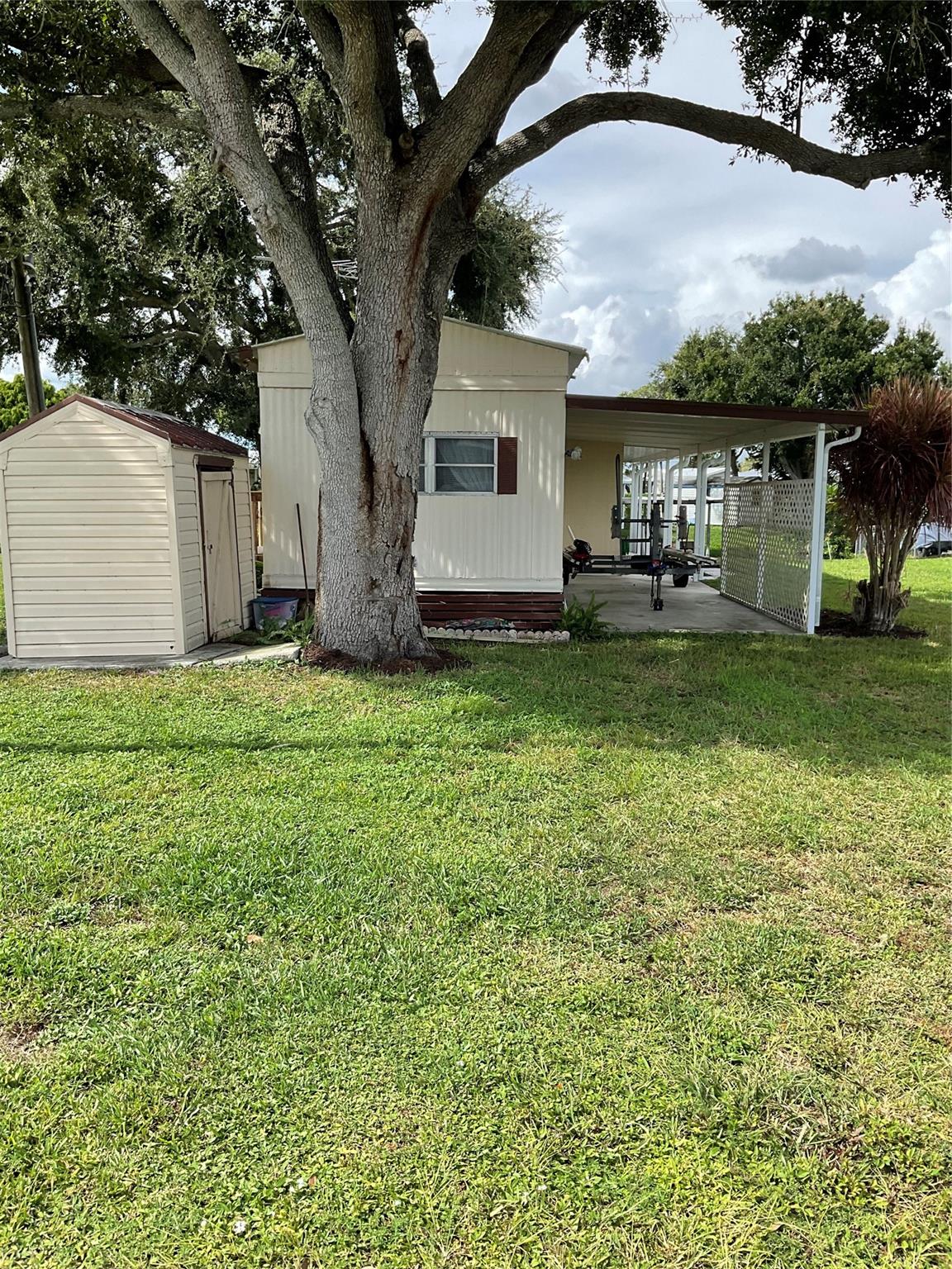 Buck Head Ridge- Lake Okeechobee Access. Attention all fishermen! Furnished 2-bedroom/ 1 bath SWMH built by Fleetwood, located on through canal just Minutes from Lake Okeechobee!  Features include, open floorplan, Laminate flooring, solid wood cabinets, solid surface countertop, 2017 Metal roof, Central Heat and Air, Covered Patio area, Good Seawall, large boat slip, sprinkler system off canal, mature landscaping.  Property needs updating, all measurements approximate. Call today for more information.