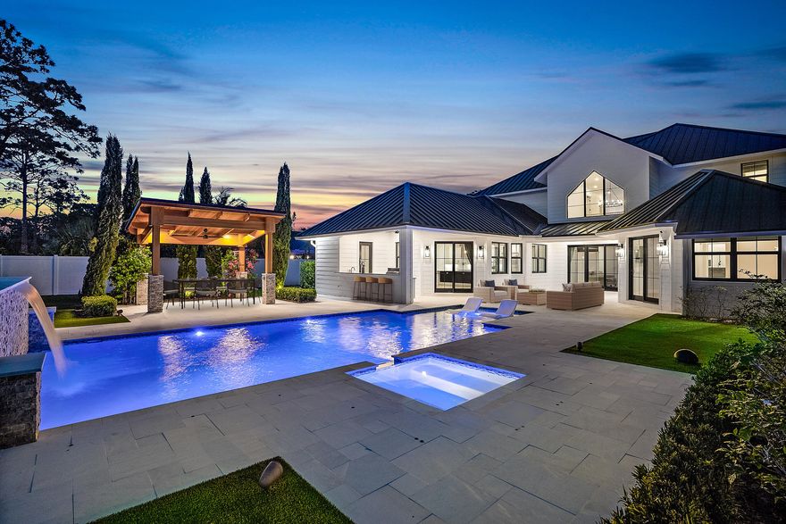 Hello gorgeous! This ONE-OF-A-KIND custom built waterfront home has everything you've been searching for, including that modern farmhouse vibe, five large bedrooms PLUS an office AND a loft (playroom, gym, home theater, or second office!) 
Situated on half an acre of private land and boasting magnificent contemporary design from top to bottom, this stunning home was built in 2021 with over 4,600 sq ft and not a single detail was spared. It is a two-story transitional modern beauty and was expertly designed for entertaining. You will be blown away by the attention to detail and HIGH-END finishes throughout the home. Nestled on a quiet and private street in Jupiter, 18764 Jupiter River Dr sits on just over 0.5 ACRES with NO HOA restrictions and low Martin County taxes! (click to read more) You will be the envy of the block with this IMPRESSIVE front elevation with cascading rooflines, decorative Cypress shutters, HUGE modern windows and painted Chicago Brick details. The WOW FACTOR and curb appeal on this home is truly BREATHTAKING! The front is complete with GORGEOUS landscaping and uplighting, a SPACIOUS brick driveway with plenty of room for multiple vehicles, and a unique side driveway with MODERN turf inlays perfect for parking a boat trailer, small RV or any other recreational vehicles. With no HOA the options are endless!!!


Upon entering the front double doors your gaze will move up toward the GRAND porch entryway which continues into the GREAT ROOM of this spectacular home. To the left of the front door is a built in drop zone leading into a HOME OFFICE with CUSTOM cabinets and quartz countertops with rustic wood-look tile flooring. Down the hall to the right of the front entryway is a FULL guest bath with walk-in shower, a laundry room complete with sink and AMPLE under stair storage for all of your bulk items. At the end of the hall is a SPACIOUS and PRIVATE first floor guest bedroom perfectly accessible and tucked away for guests!!!


BEAUTIFUL hand scraped white OAK flooring continues into the GREAT ROOM anchored by a custom GAS burning brick fireplace with OAK MANTLE overlooking a CRYSTAL BLUE POOL and covered lanai. The over 20ft great room ceilings and LARGE 2ND STORY windows flood the entire house with AMPLE natural light.


Situated on the first floor, off of the great room, is the PRIMARY SUITE. The OAK floors continue into the double doored primary bedroom complete with CUSTOM decorative matching OAK BEAMS, chevron patterned shiplap and floor to ceiling sliders out to your backyard which feels like a true OASIS! The Primary bedroom closets feature twin walk in's with CLOSETS BY DESIGN built in shelving and cabinetry. The primary en-suite is a true RETREAT, with a luxurious soaking tub, double sided walk in shower complete with rain head and DOUBLE shower sprayers. 


Continuing off of the great room is a full FORMAL DINING room with decorative floor to ceiling wainscoting perfect for Holidays and family gatherings. The GOURMET kitchen is a chef's DREAM! Featuring top-of-the-line appliances, a large WATERFALL QUARTZ island, CUSTOM HOOD, large apron sink, TITAN Beverage and Wine Fridge and 6-burner GAS GE Monogram stove. Connecting the Kitchen and Formal Dining Room is a BUTLER'S pantry made for whipping up a cocktail or enjoying a morning latte with friends and family!!! A breakfast nook with bench seat, and family room with adjoining Cabana Bath round out and complete the First Floor.


Not to be overshadowed by the great room, the kitchen side FAMILY ROOM is teeming with details and carries on the OAK beams with coordinating floating oak shelves and a custom media console.
Heading upstairs, notice ornamental vertical IRON balusters lining the staircase and a MASSIVE stairwell window. The upstairs catwalk overlooks the Great Room and you will find the remaining 3 bedrooms along with a BONUS room!


The guest bedroom and bathroom upstairs is connected to a BONUS room that can be used in a multitude of ways. This space can be a MEDIA ROOM, workout space, PLAYROOM and even function as a Mother-in law-suite or living space for a Nanny or au pair! Across the catwalk are two additional bedrooms with an adjoining Jack-and-Jill full bathroom with DOUBLE vanity.


The outdoor space is just as, if not MORE, impressive as the interior, with a DAZZLING in-ground HEATED saltwater pool, spa, turf lawn, putting green with tee box, a PERGOLA and expansive sandblasted MARBLE patio area perfect for hosting barbecues and pool parties YEAR ROUND. Entertain guests with the outdoor SONOS sound system, sure to enhance the experience for the many gatherings you will be hosting.


The OUTDOOR KITCHEN boasts a gas grill that is hooked up to a 1,000 GALLON PROPANE tank and a beverage fridge, ice maker and sink. The property also features a PRIVATE DOCK, with 10,000 LB BOAT LIFT allowing you to enjoy the water right from your own backyard!!! Right outside the canal enjoy FISHING, water skiing, and tubing on the SERENE Loxahatchee River. 


A mere 15 minutes to the Jupiter Lighthouse and you can be fishing offshore, docking at one of the nearby WATERFRONT restaurants or enjoying the INTRACOASTAL waterways of Jupiter! This home is ready to withstand the elements with FULL IMPACT GLASS windows, doors and sliders throughout AND also includes a 38kw WHOLE HOUSE GENERATOR. 


18764 SE Jupiter River Drive, located on a quiet and PRIVATE street, and conveniently located off of Island Way, you are in close proximity to I-95 and Florida's Turnpike. You are also only minutes to the pristine local beaches, some of the best restaurants in Jupiter, world-famous golf courses, esteemed shopping, and to renowned state parks, kayaking, hiking trails and more! 


Do not miss the RARE OPPORTUNITY to own this LUXURIOUS and CUSTOM detailed home in one of the most desirable areas in Jupiter!