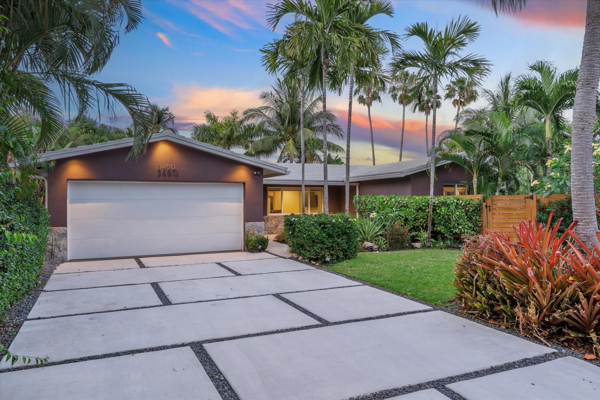 Loft-style home with open layout, polished concrete & Italian tile floors, and water views from every room. Set on a private, elevated 'curved' corner lot with mature palms, mango, & bamboo large windows connect nature from outside to inside, with a modern, mid-century feel. Two spacious primary bedrooms with ensuite baths, plus a third bedroom with bonus office alcove. Gourmet kitchen features quartz countertops, induction cooktop, black stainless appliances, pro-grade hood, bar & prep sinks, & custom soft-close cabinets. Space saving, modern pocket doors throughout. Fully furnished with Modani furniture (minus a few heirlooms). Ocean access canal for kayaking, manatees, & fishing. Close to dining, breweries, beach, Fresh Market, Wilton, & more. No HOA, 2-car garage, impact windows/doors.