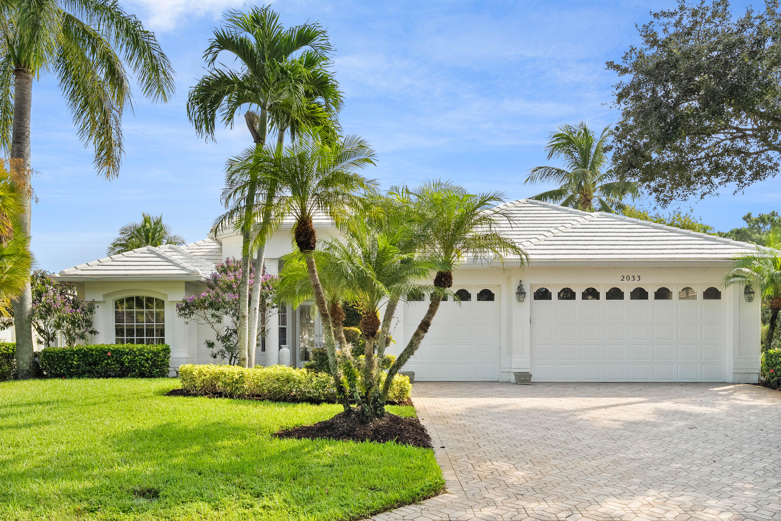 ''Timeless neoclassical home with modern renovations in the man-gated Monarch community of Palm City. Featuring light, neutral vinyl floors, soaring 12' ceilings in the main living areas, and 10' ceilings throughout the rest of the home, this residence is filled with natural light from abundant windows. The updated kitchen showcases white quartz countertops and stainless steel appliances. Floor plan includes a formal dining room, living room, and family room, plus 4 bedrooms and 3.5 baths. One bedroom is an en suite ideal for a nanny or in-law quarters, while another bath serves as a cabana. Enjoy tranquil lakefront views, beautiful mature landscaping, a 2021 roof, and complete hurricane panels. Community amenities include a clubhouse, pool, tennis, fitness center, and optional golf club