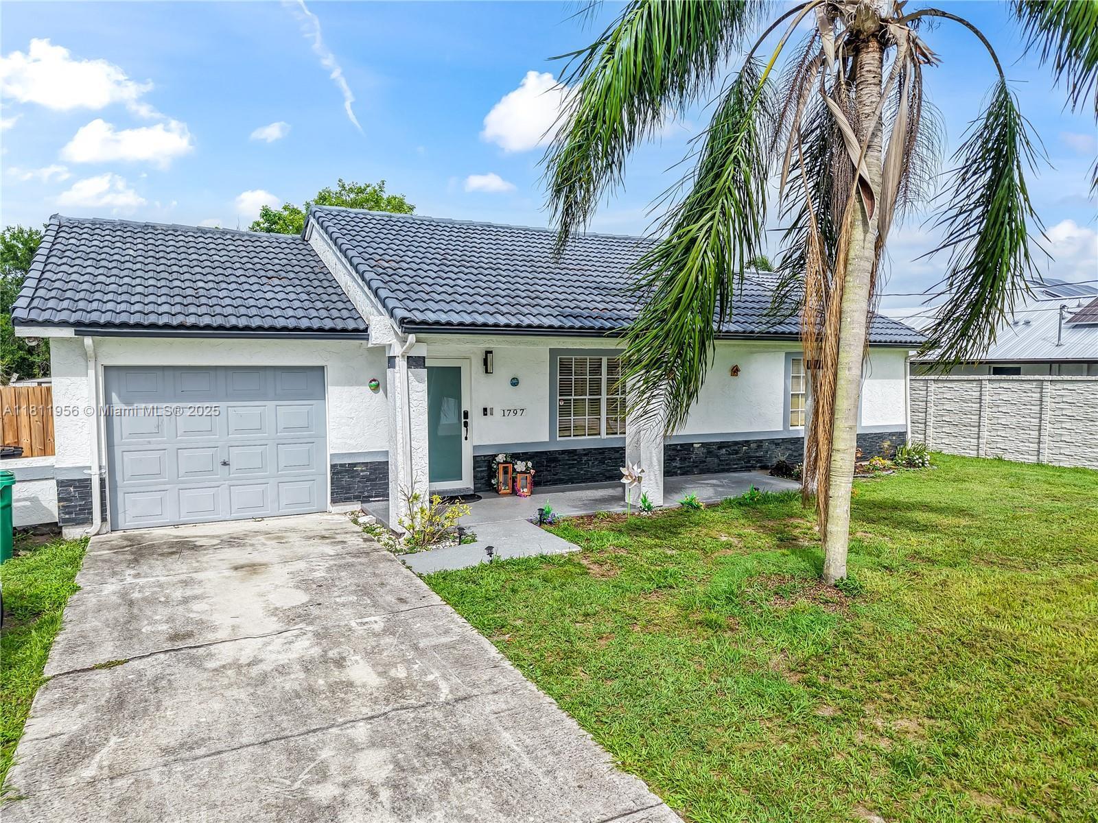 Welcome home to this bright and beautifully maintained 3BR/2BA in the heart of Port St. Lucie. Sitting on a 10,000 sq ft lot, this home features vaulted ceilings, an open layout, and natural light throughout. The split-bedroom plan offers privacy, and the updated kitchen is perfect for gathering. Enjoy peaceful mornings on the screened patio and a backyard full of potential. Solid frame construction, tile roof, and west-facing exposure for stunning sunsets. Centrally located near parks, shopping, and highways. This one just feels like home.
