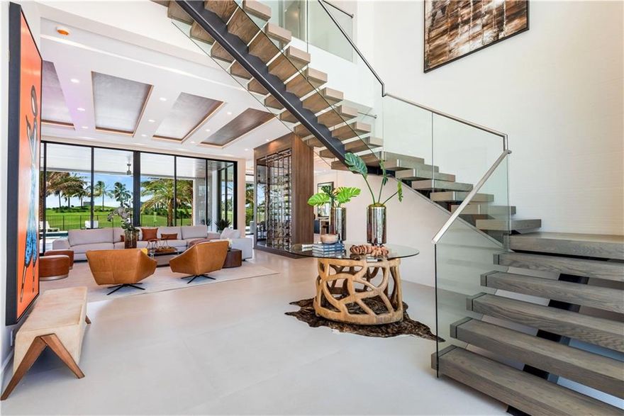 This newly built, modern two-story custom-designed residence is 6,735 sqft of luxurious living space featuring 5 bedrooms, 6.5 baths, an office, club room, elevator & a split 4-car garage.  Enjoy sweeping views of rolling fairways on the golf course from most every room including the covered verandas - each is over 900 sqft., 64' salt-water heated pool including spa, and chef's outdoor kitchen. The grand glass foyer invites you into an open floorplan with soaring 12' ceilings & rich interior finishes for those who demand the best. The upstairs living area, off the lavish owner's suite provides serene views. Located in the exclusive guard-gated community of only 36 lots, The Enclave at Coral Ridge Country Club, this estate will offer room to entertain & enjoy the South Florida Lifestyle.