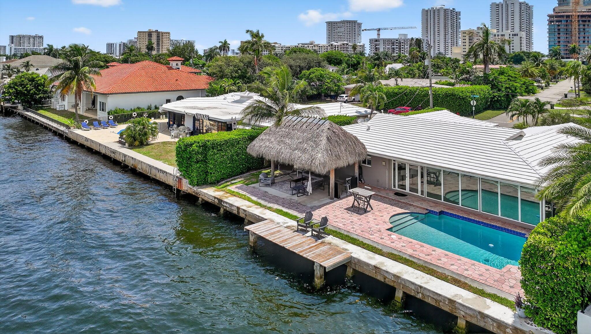 Experience the pinnacle of South Florida coastal living in this impeccably maintained single-story deepwater estate, offering 90 feet of prime Intracoastal frontage, a sparkling heated private pool, and the freedom of no HOA. This 4 bedroom, 2 bathroom, 2 car garage residence is thoughtfully designed for both everyday comfort and elevated entertaining. Ideally located just one block from the beach, the home seamlessly blends indoor and outdoor living with multiple areas for gathering, relaxing, and enjoying the tropical surroundings all in a highly sought-after, upscale enclave of Lauderdale-by-the-Sea.